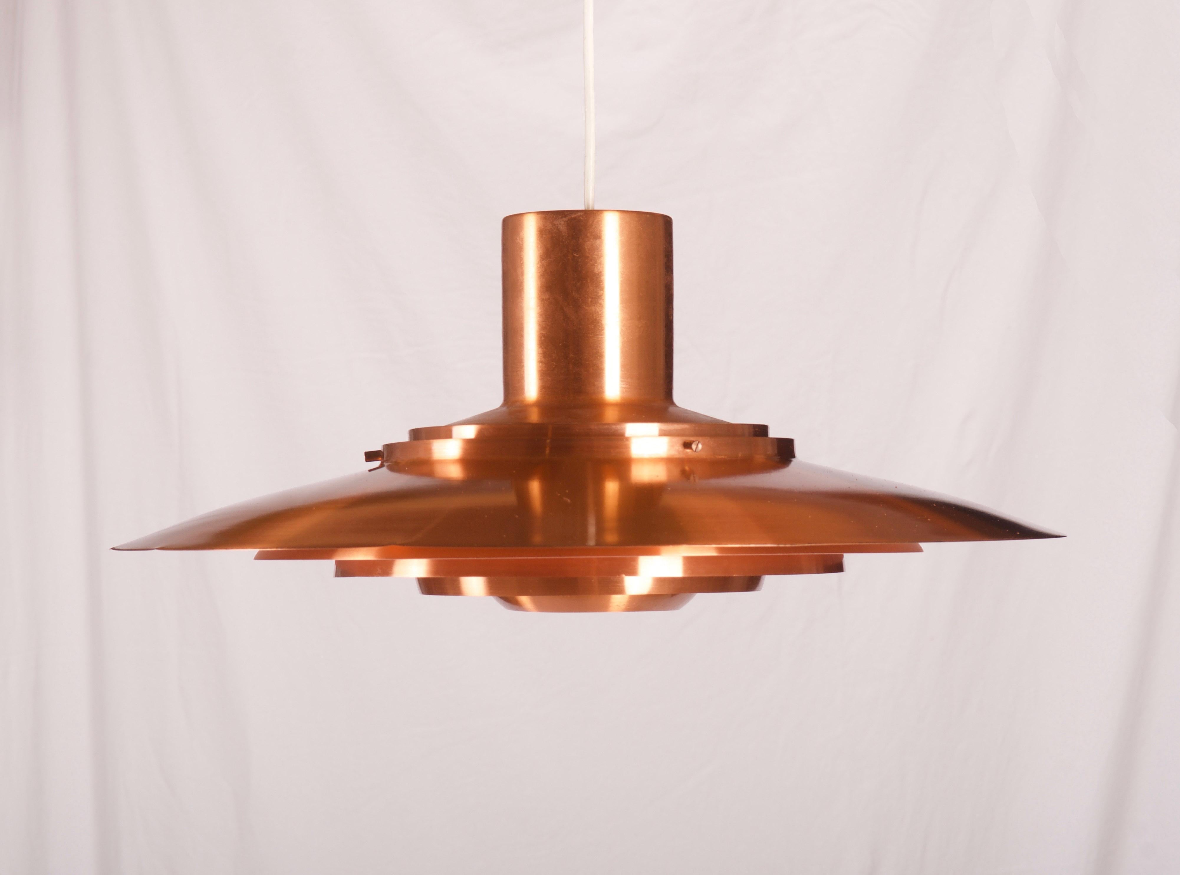 Aluminium pendant copper-plated comprising for five tiers, fitted with one E27 socket up to 100watts. Designed by Preben Fabricius & Jørgen Kastholm for Nordisk Solar Compagni in 1964. Height of the lamp only 29 cm.
 