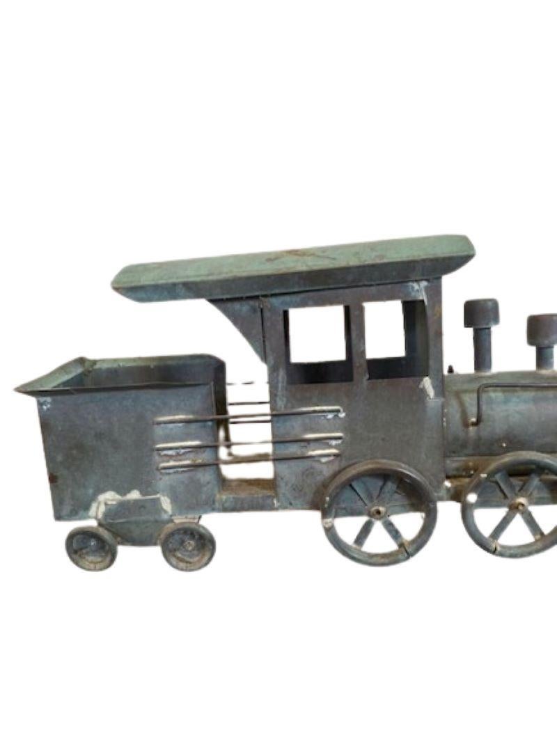 Antique Copper Railroad Locomotive and Tender Weathervane, circa 1900, a hand crafted sheet metal weathervane in form of a 19th Century wood or coal driven steam engine railroad locomotive and accompanying fuel tender. Coincidentally it is the
