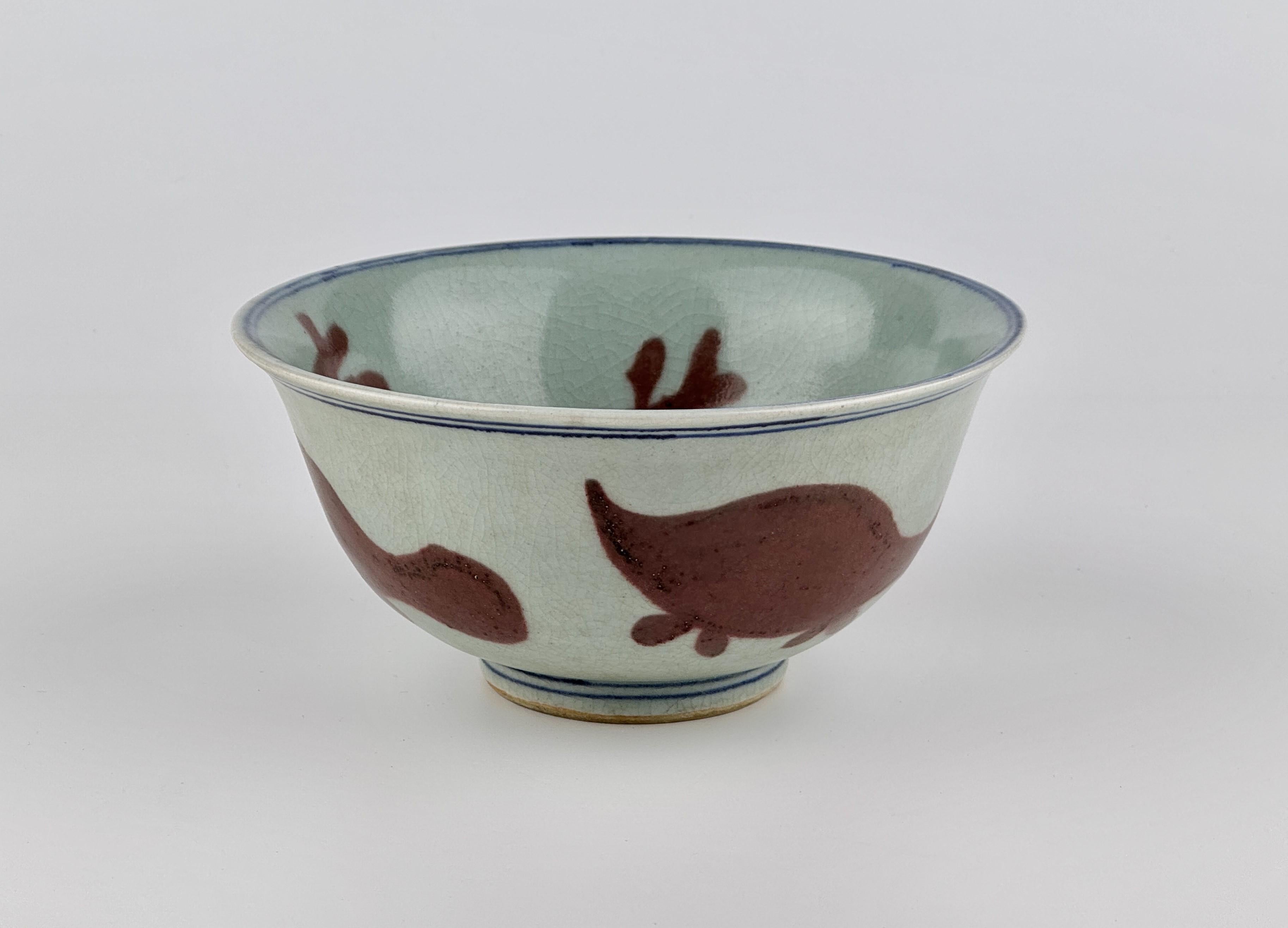 A copper-red produced in Jingdezhen, China, during the Ming to early Qing dynasty (15th–17th century). It features a copper red applied over a bluish-white glaze, which is glaze type of Ming Dynasty. The exterior is decorated with fishes, while the