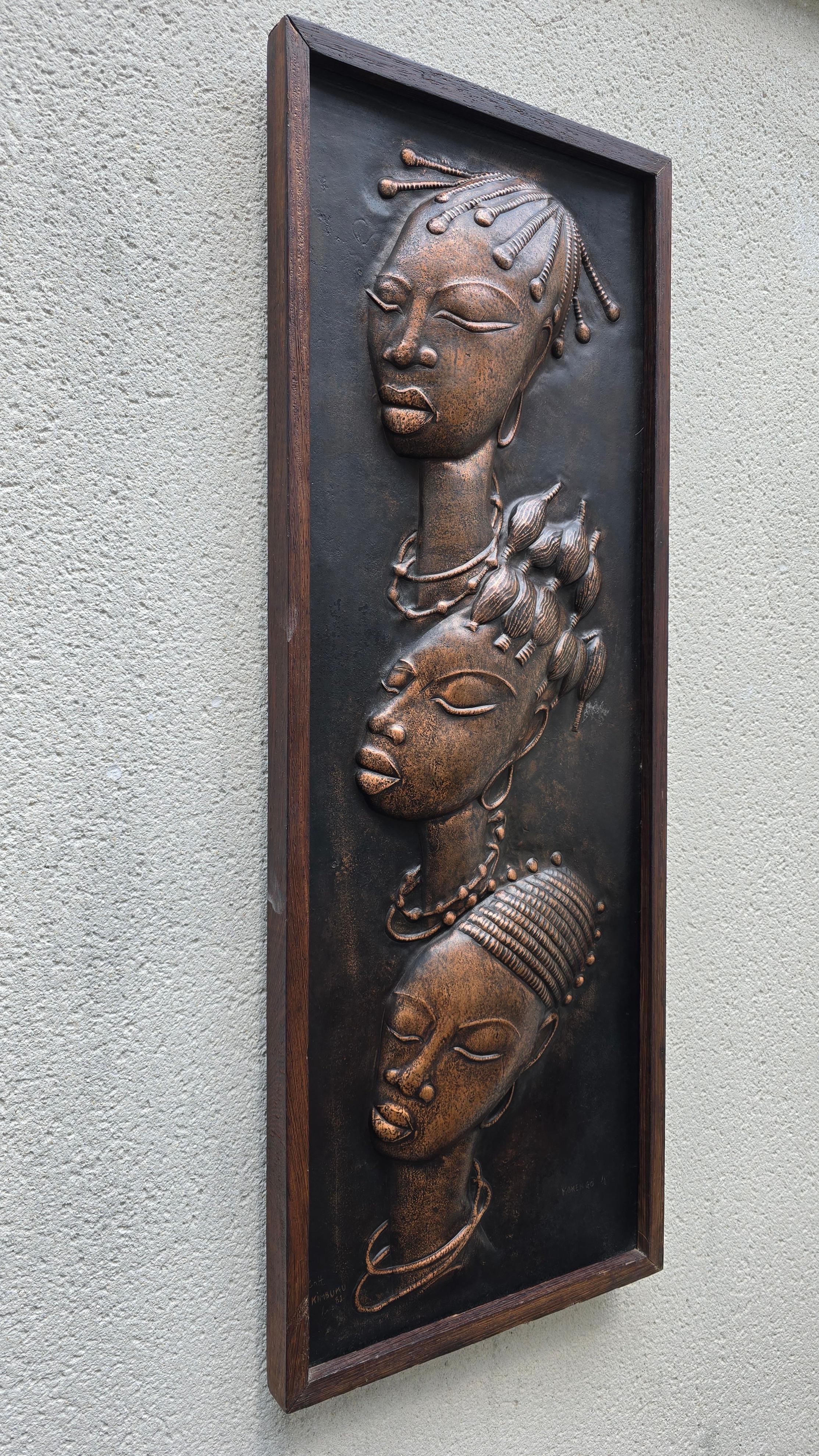 Copper Relief Artwork – Female Portraits, Congo (1981)

A striking and original African copper relief artwork from 1981, handcrafted in the Democratic Republic of Congo. The piece features three stylized female portraits in profile, vertically