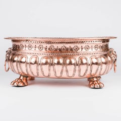 Copper repoussé planter with Lion's head ring handles and paw feet