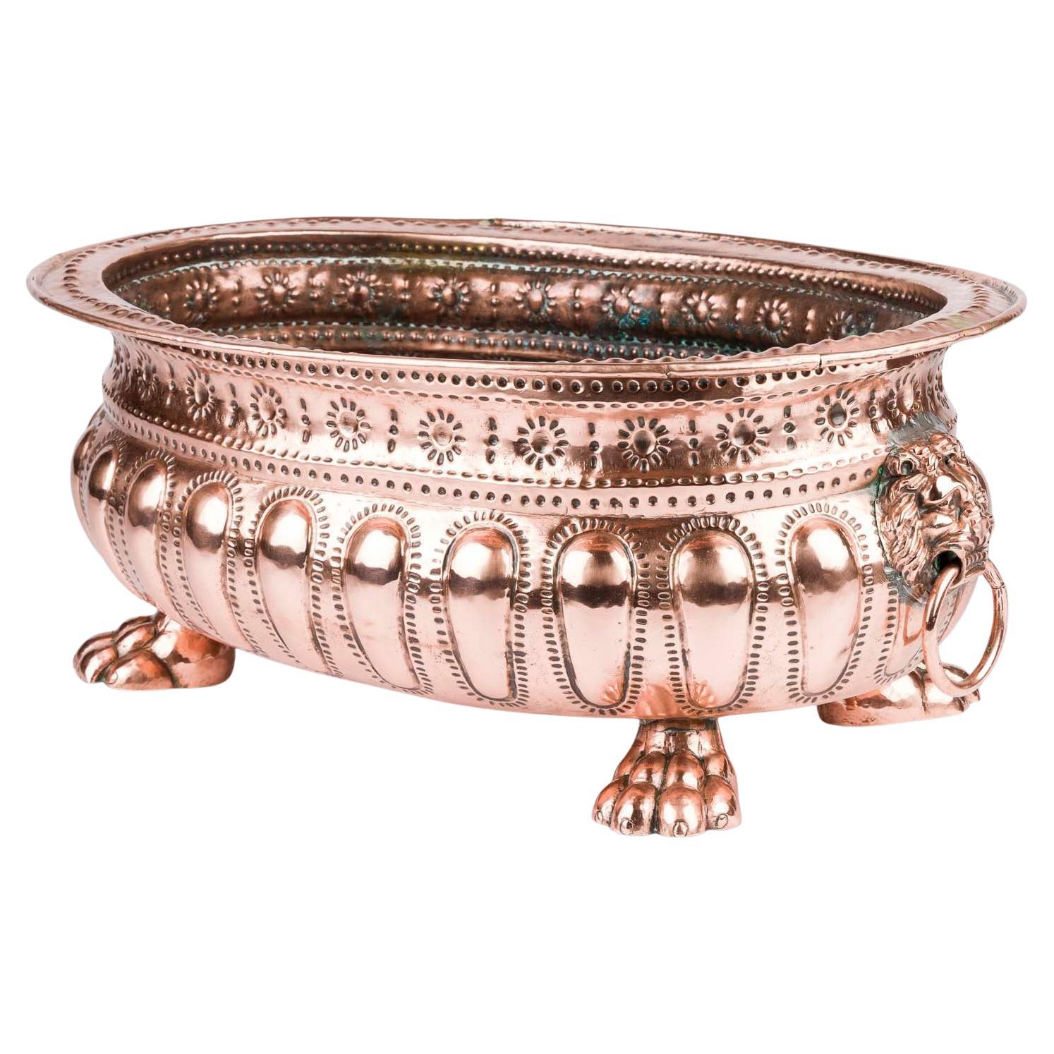 Copper repoussé planter with Lion's head ring handles and paw feet