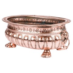 Copper repoussé planter with Lion's head ring handles and paw feet