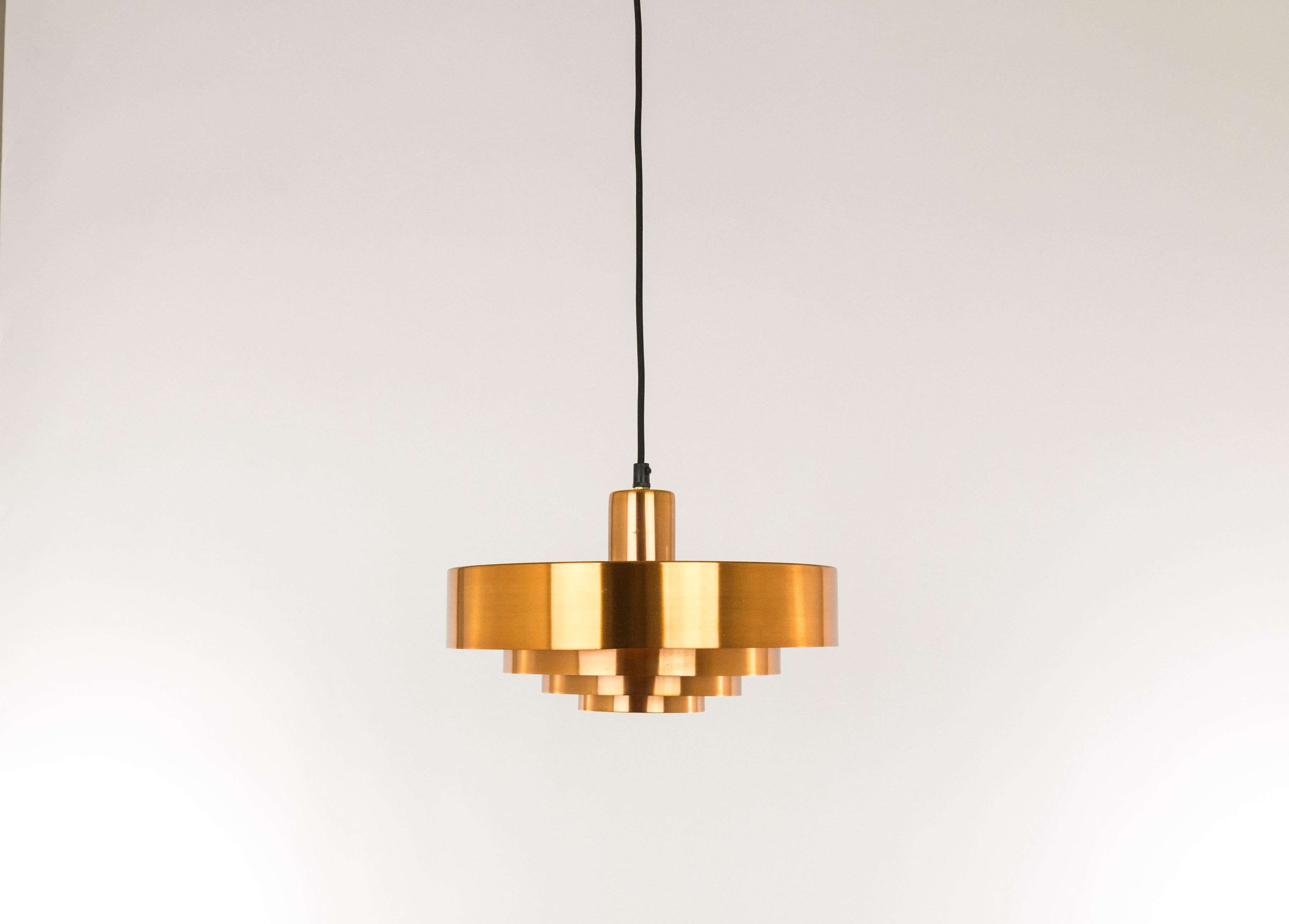 Copper Roulet pendant designed by Jo Hammerborg in 1963 and produced by Fog & Mørup in Denmark.

The lamp consists of four rings encompassing each other. Roulet was only produced in solid copper. Specific to this lamp is that the orange lacquer on