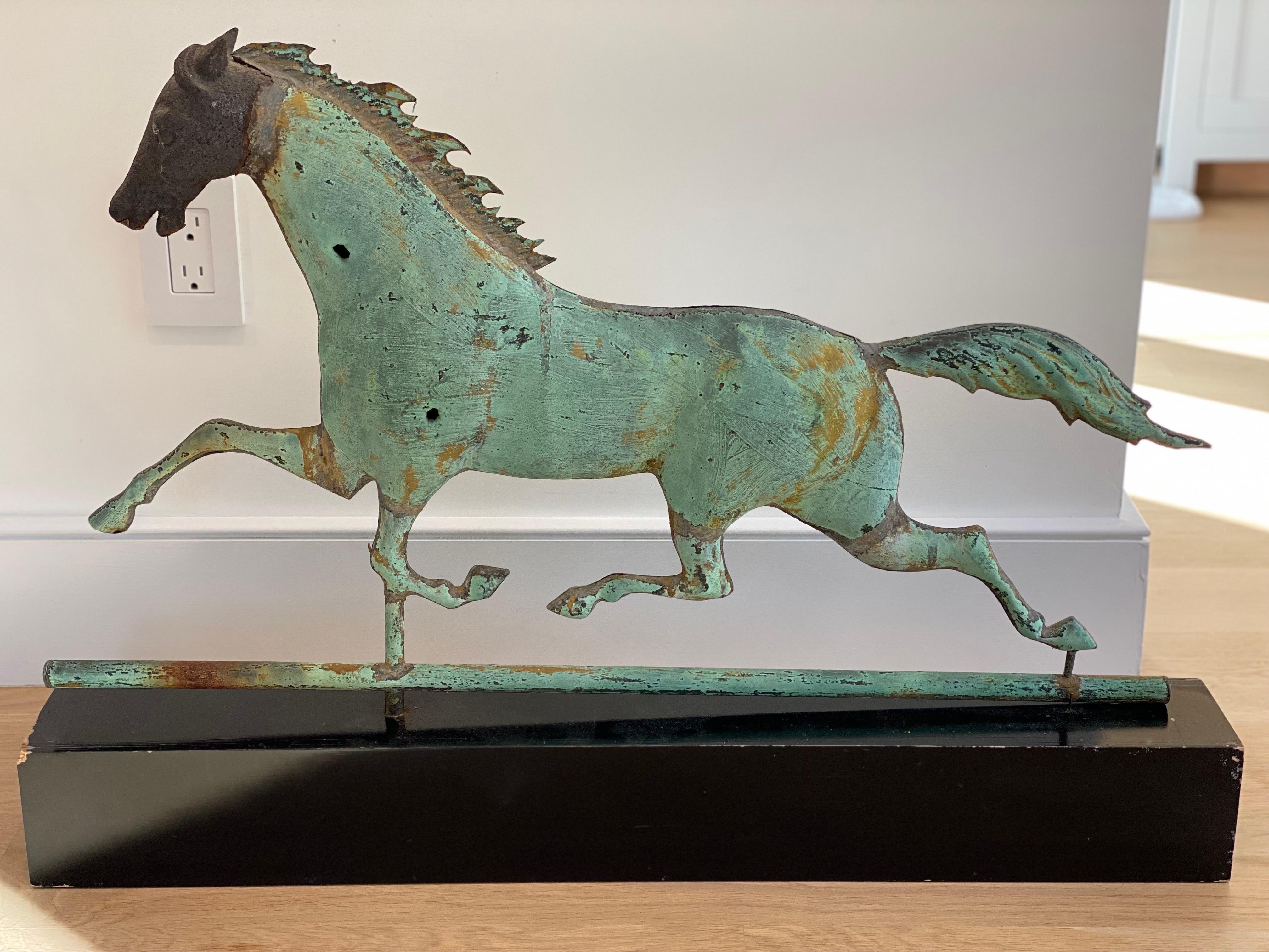 Copper Running Horse Weathervane, New England
Nice looking running horse weathervane with verdigris patinated copper finish. Head shows further weathering. Mounted on a black painted wooden plinth. Wear to edges of the box. General wear to