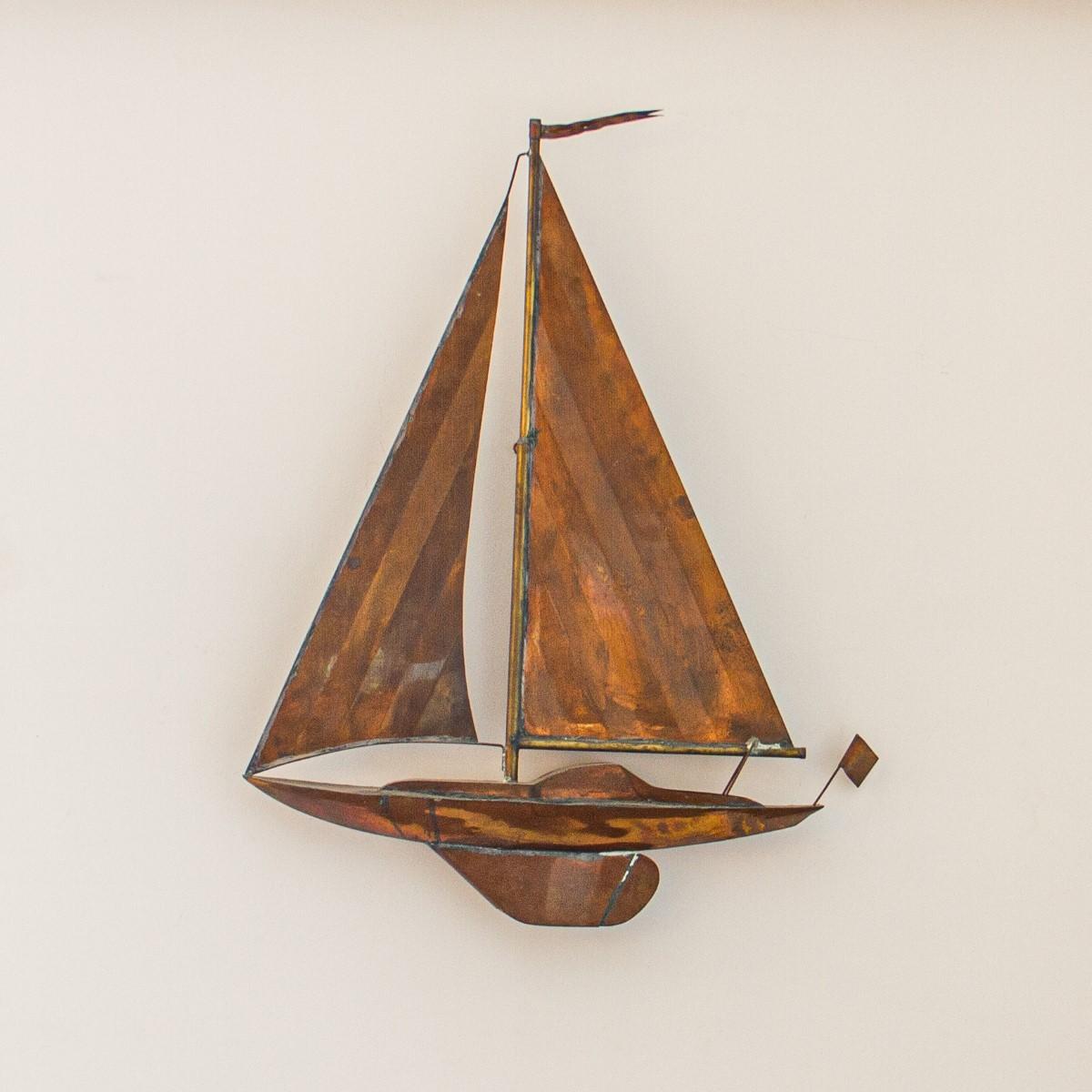 A sheet copper and brass detailed wall sculpture in the manner of Curtis Jere, showing a yacht under full sail, circa 1970s.

Curtis Jeré is the collaboration of two metal sculptors Jerry Fels and Curtis Freiler who founded the company Artisan House