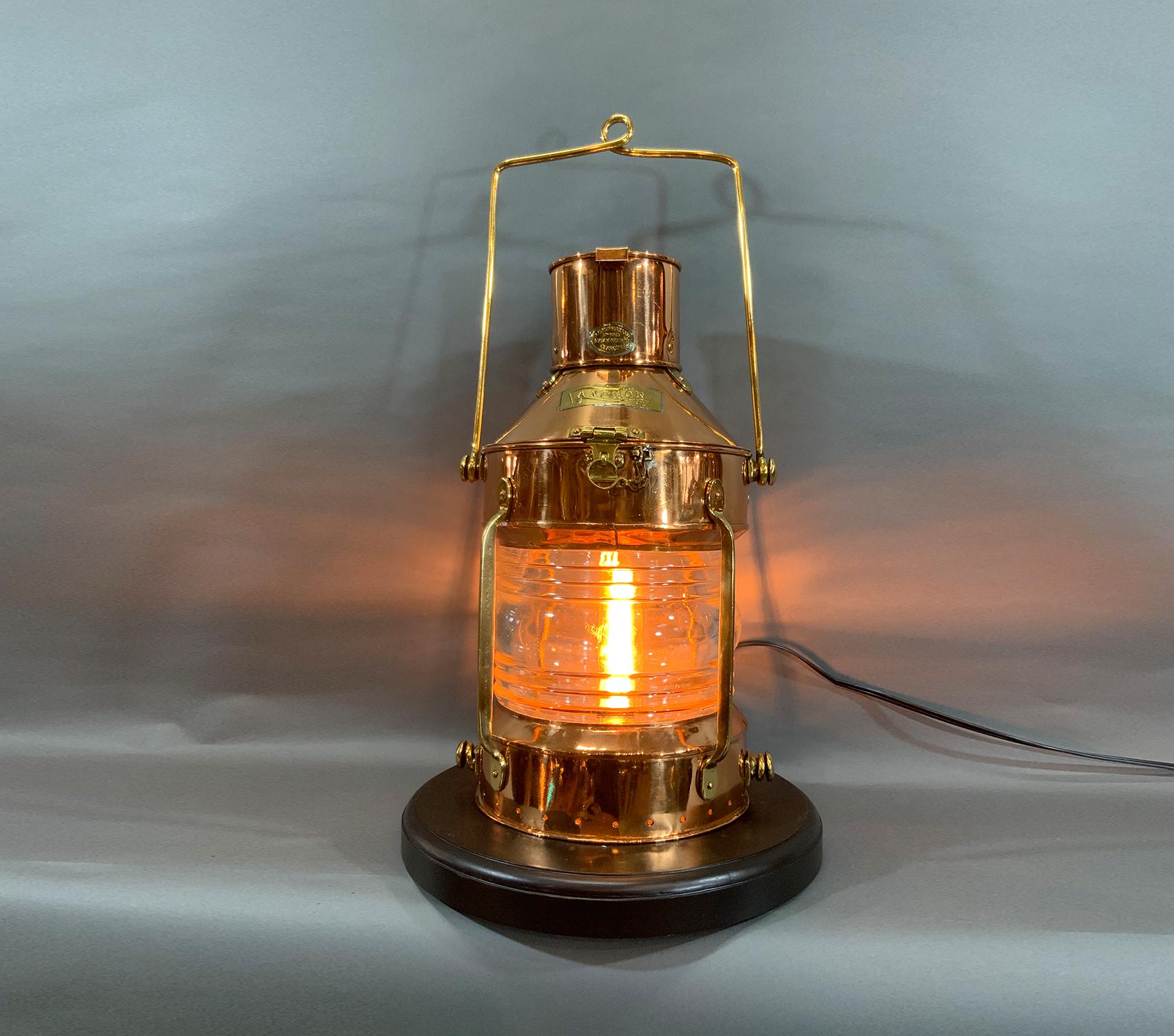 Copper and brass ship’s anchor lantern with maker’s badge from R.C. Murray Limited, 37 Cavendish St., Glasgow. Meticulously polished and lacquered. Brasses include handles, legend plates, protective bars, hinges and hasp. Mounted to a wood base.