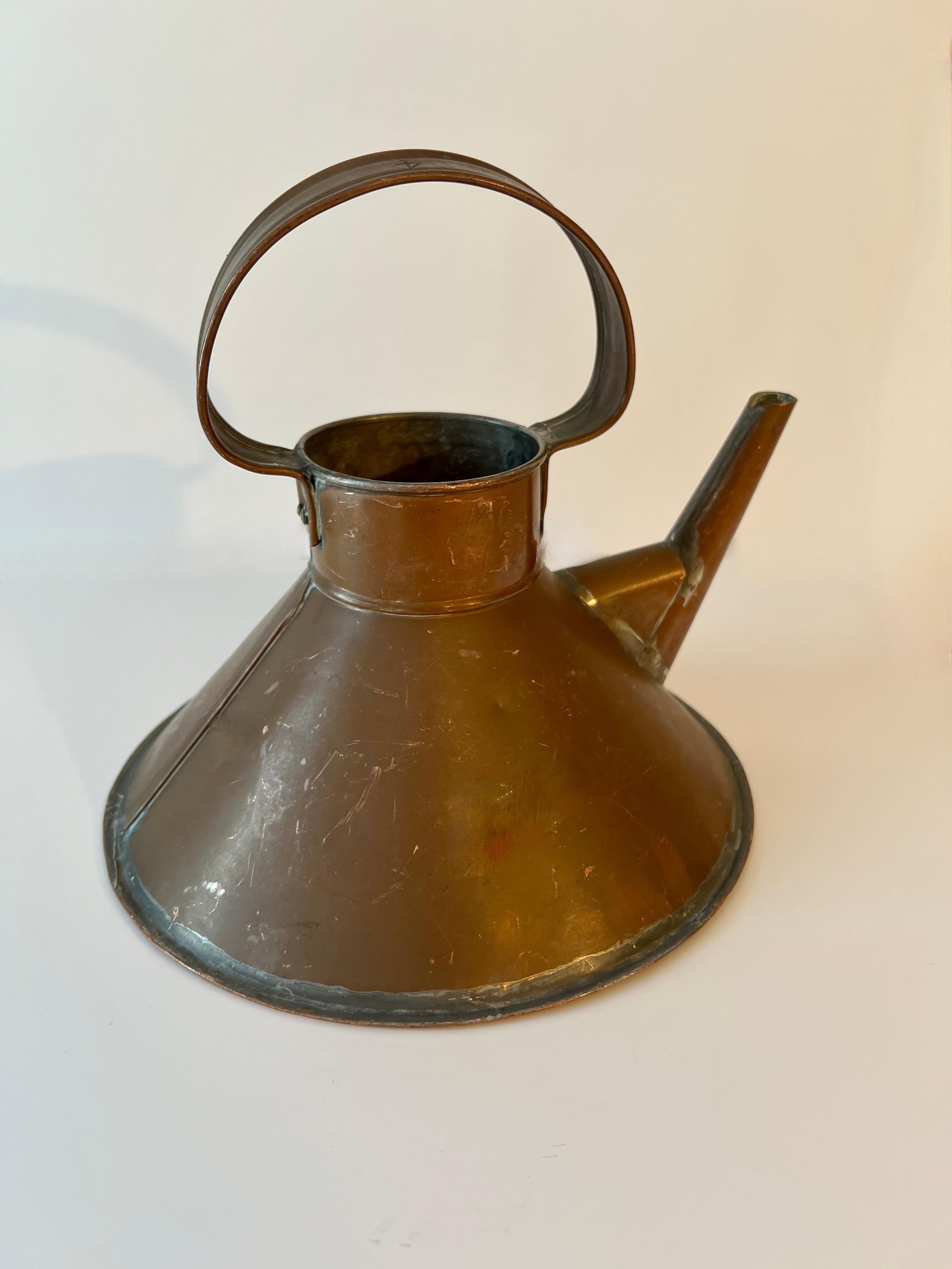 A unique shape patinated copper watering can or ships kettle.  A full functional watering can and also a handsome decorative piece for the kitchen or garden area.

 A compliment to many spaces and also a nice house warming gift, house warming gift