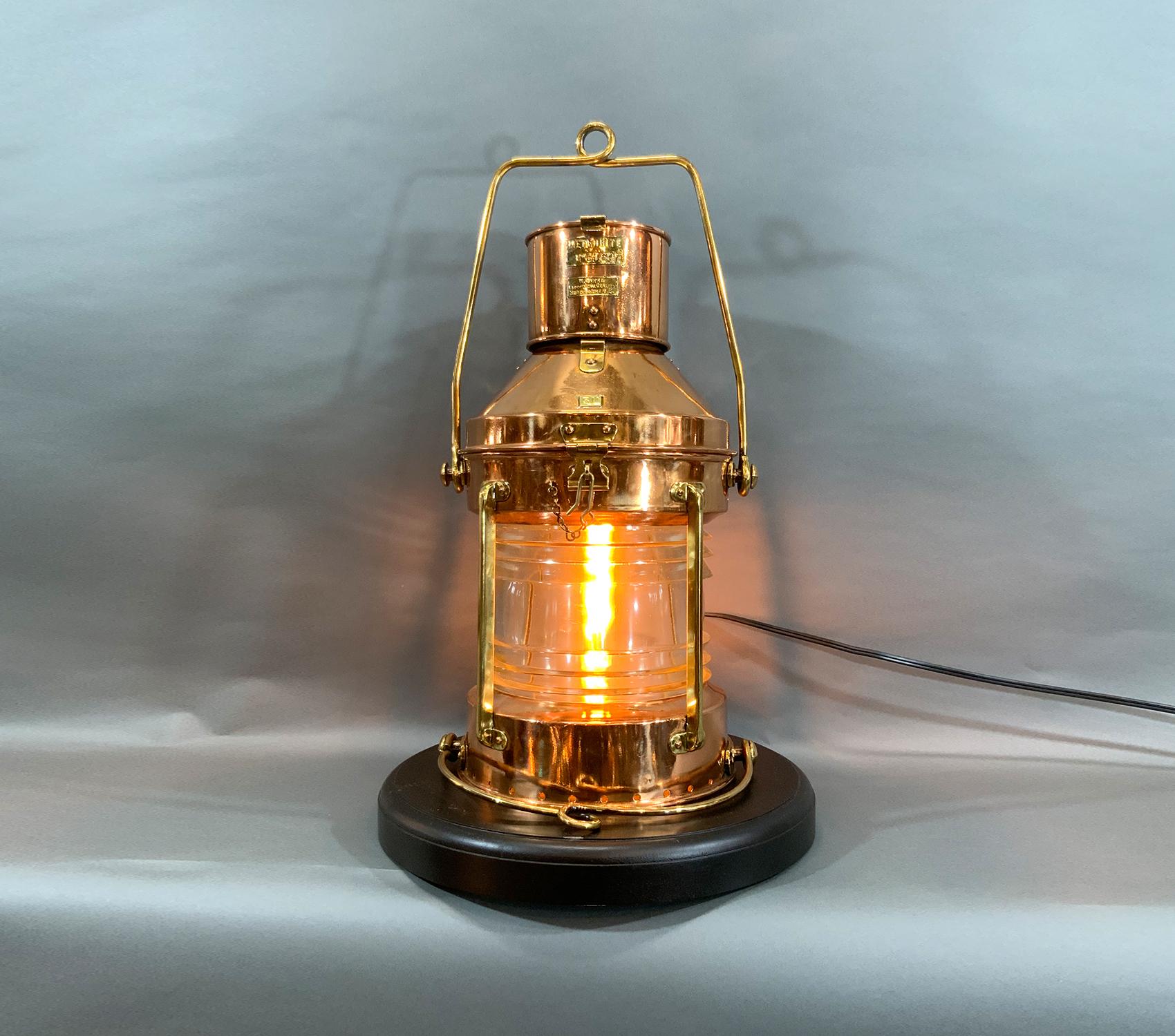 Highly polished and lacquered solid copper ship’s lantern with lacquer finish. Fresnel glass lens. Wired with electric socket and Edison bulb for home enjoyment. Fitted with brass handles, hinge, hasp, bars, etc. Brass badge with serial number from