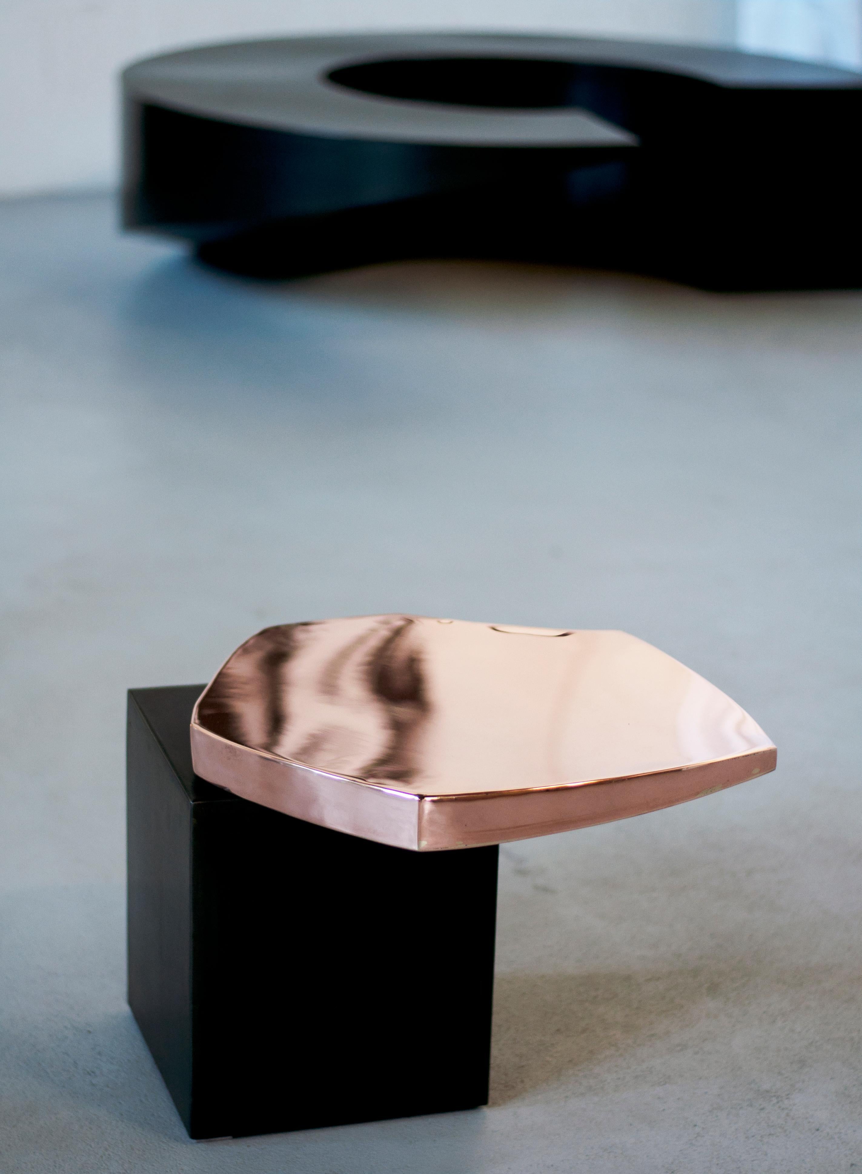 Copper Side Table by Pol Quadens 
Limited Edition Of 24+8 Pieces.
Dimensions: D 40 x W 50 x H 40 cm.
Materials: Patinated steel and polished copper.

Pol Quadens was born in Brussels. His father was active in the fields of composites the metal