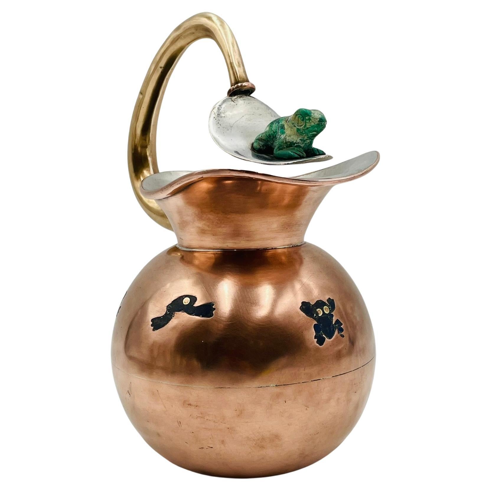 Elevate your home decor with this stunning Copper, Silver & Stone Pitcher by Los Castillo, Mexico from the 1960s. Crafted with exquisite craftsmanship at the shop of Los Castillo in Taxco Guerrero, Mexico.

 This pitcher features a unique design