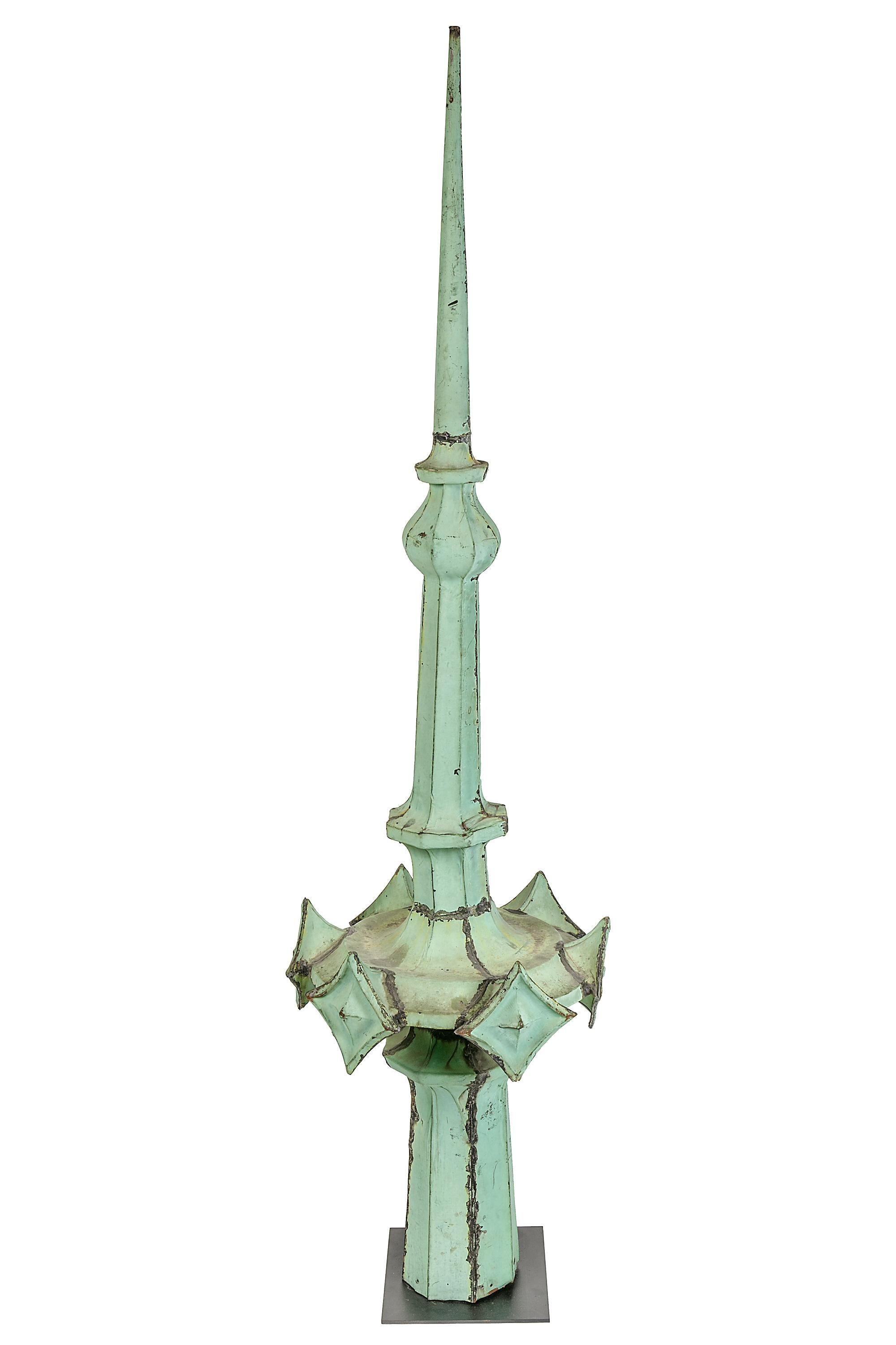This is a spire from the Woolworth Building which was designed in the European gothic style. The roof of the Woolworth Building underwent extensive repairs in the 1980s. Much of the original copper elements were removed and replaced with simplified