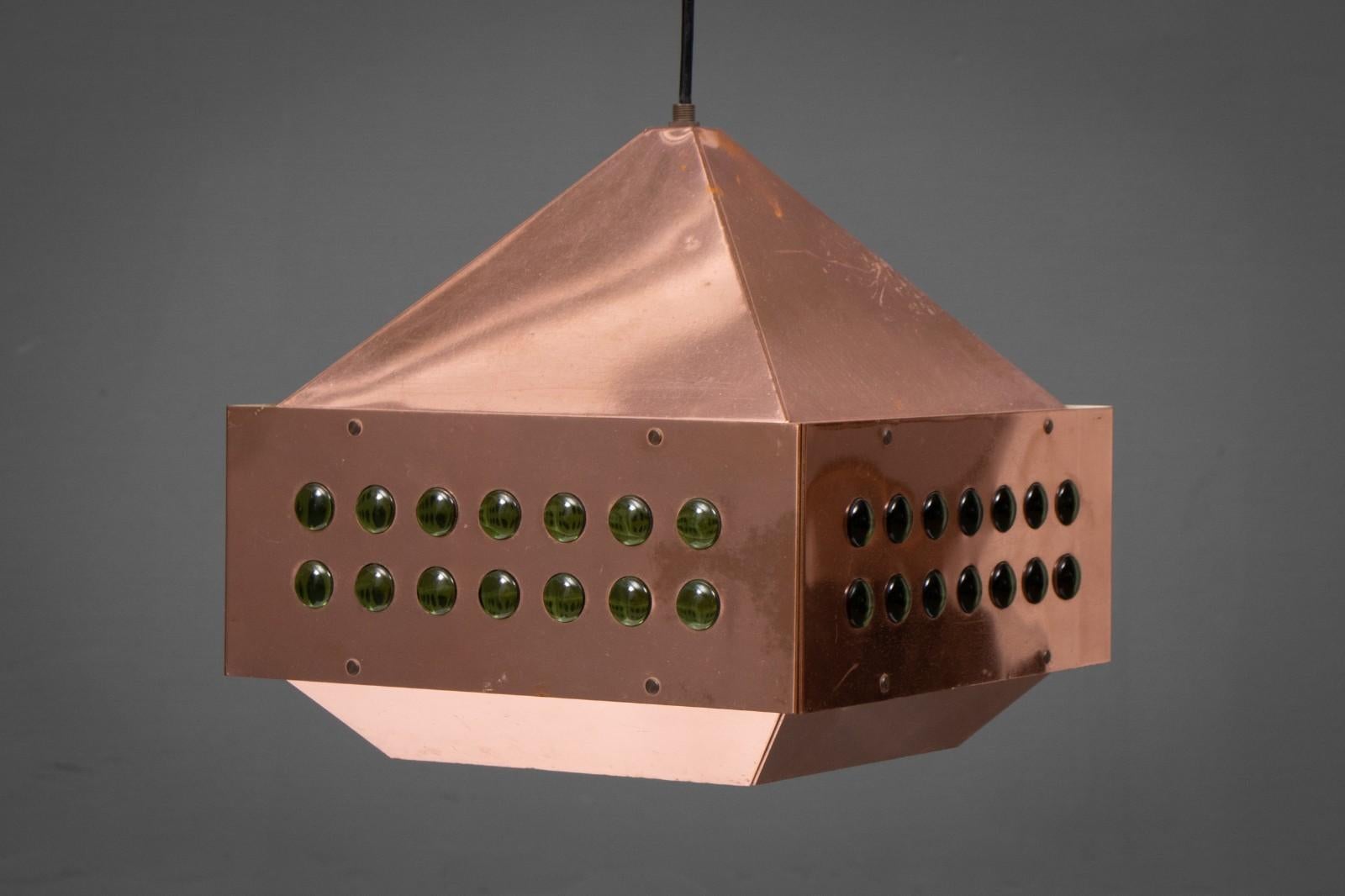 Square copper pendant lamp was designed by Hans-Agne Jakobsson for Markaryd in Sweden in the 1960s. The light spreads from the perforated copper part at the top and the white inside with green glass beads to all sides below. All are original and in