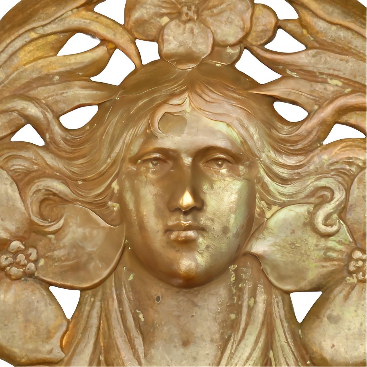 Detailed copper tone Art Nouveau brooch featuring flowers and a lady with swirling hair. Measuring 4.1cm / 1.6 inches by 4.2cm / 1.65 inches. The pin is soldered to the back. Of European origin.

This is a beautiful Art Nouveau brooch, with a copper