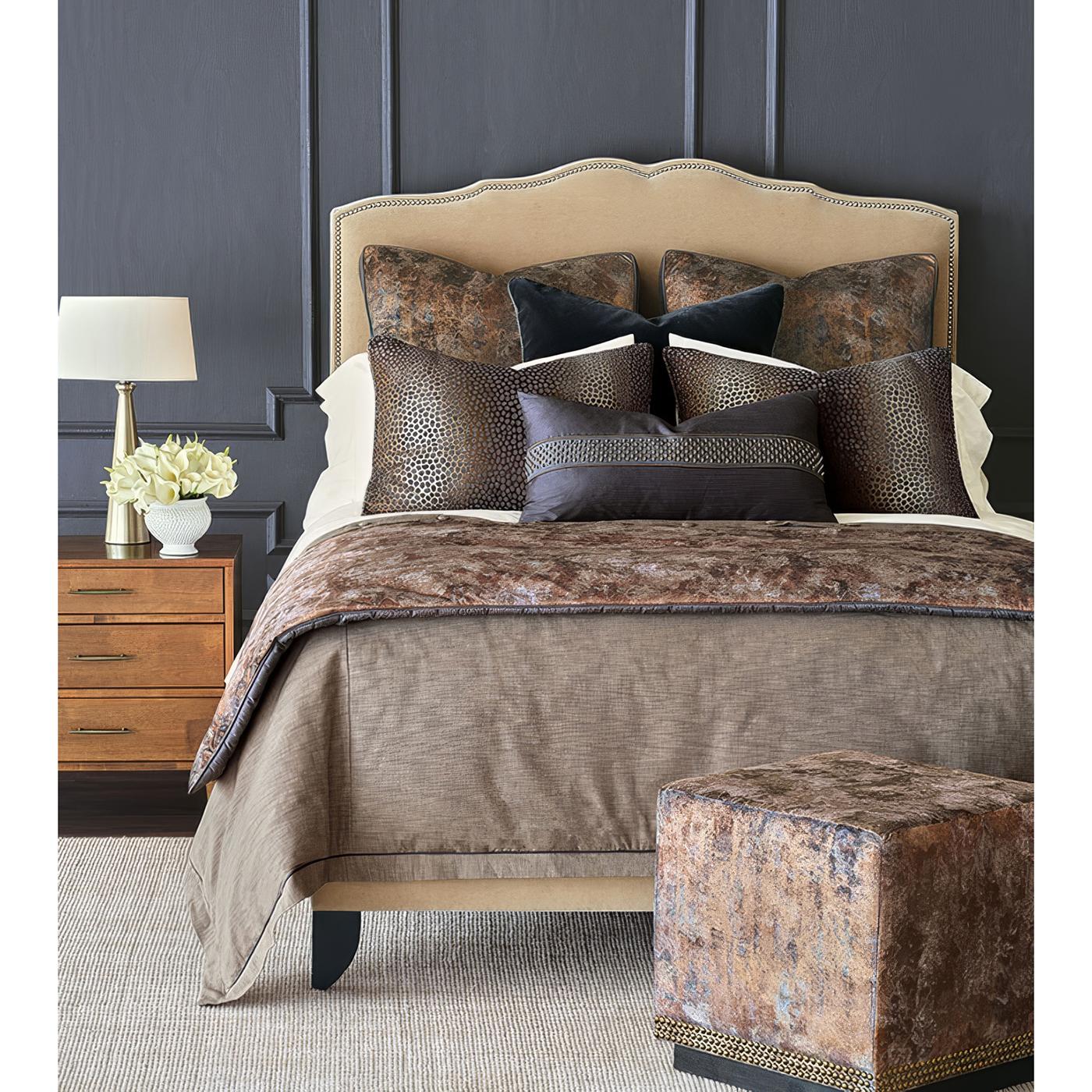Un'audace fusione di design contemporaneo e lusso senza tempo. Avvolto in velluto color rame metallizzato, questo pouf irradia calore e raffinatezza, creando un pezzo forte per qualsiasi spazio. La silhouette strutturata a forma di cubo è sostenuta