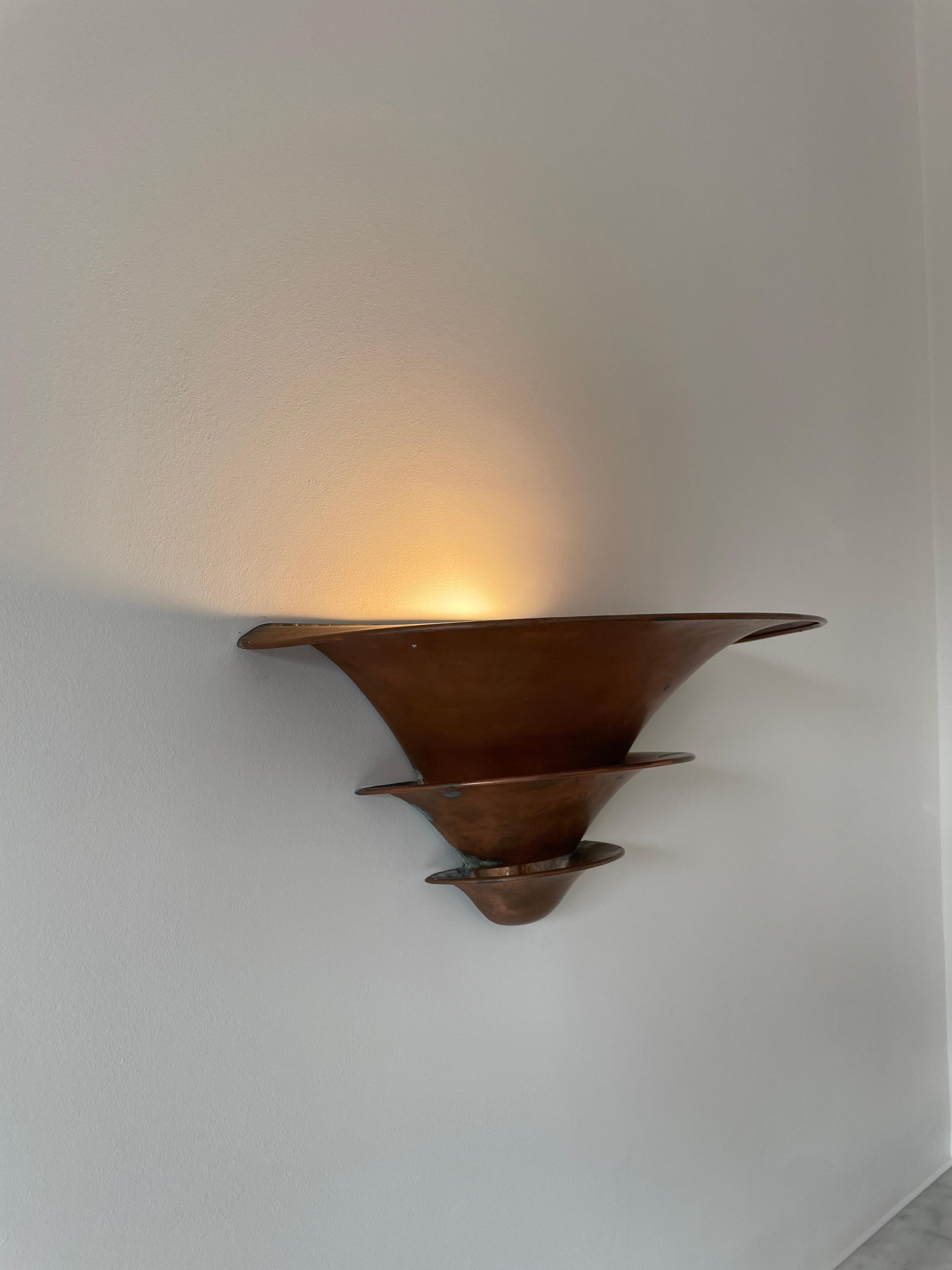 Height: 15cm
Width: 32cm

Designer: Louis Poulsen
Manufacturer: Louis Poulsen
Date: 1930s
Materials: Copper

Description: Copper wall lights from the 1930s. Light emits from each leaf of the design, creating a lovely cascade of light across the