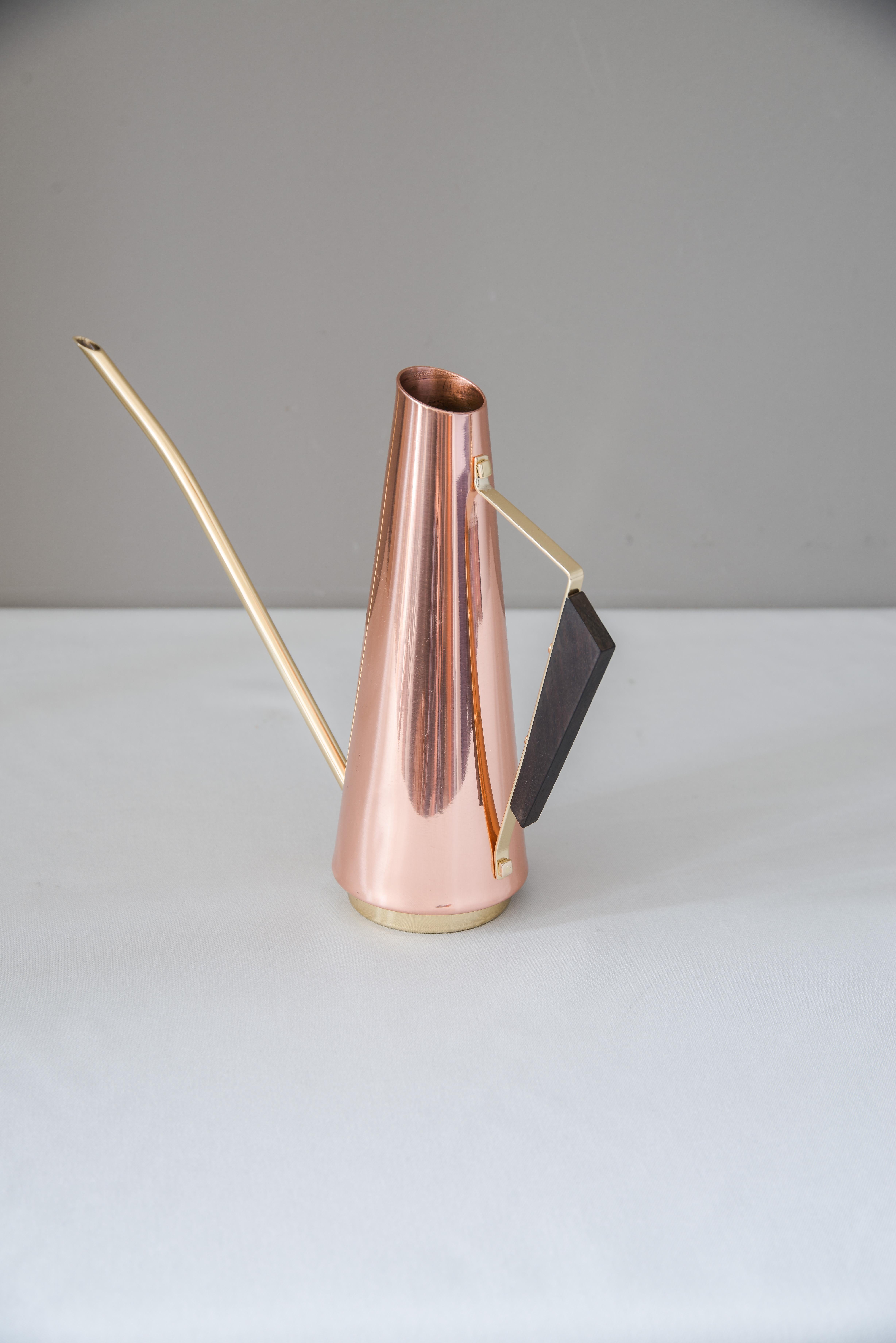 Copper watering can with wood handle and brass parts, circa 1960s
Polished and stove enameled.