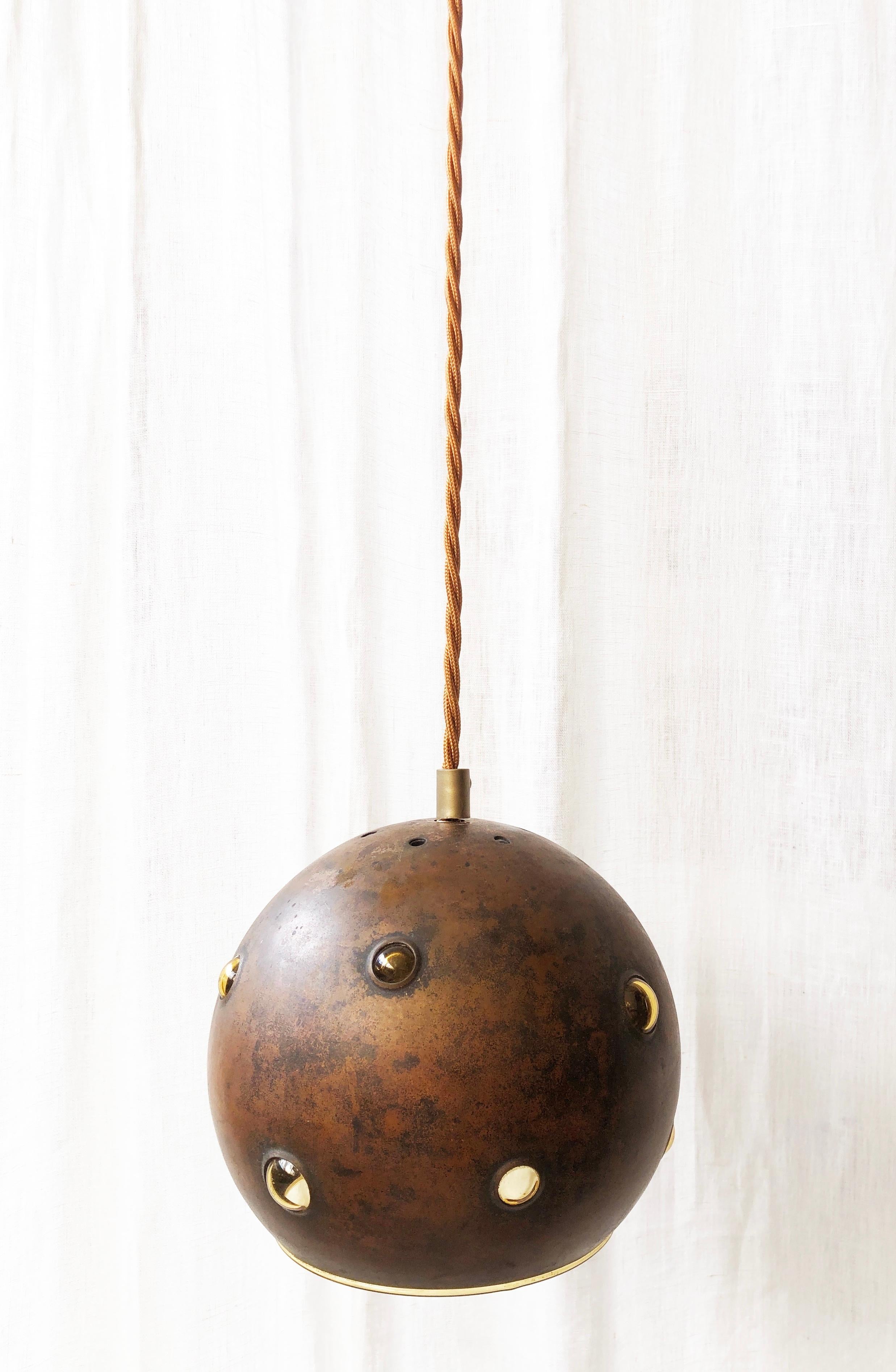 This lamps is unique in its execution & patina: like all lamps in this edition by Raak, Netherlands. 
Yellow golden glass is being blown into a copper sphere, where bubbles are being created. 

The lamp has been rewired with antique copper braided