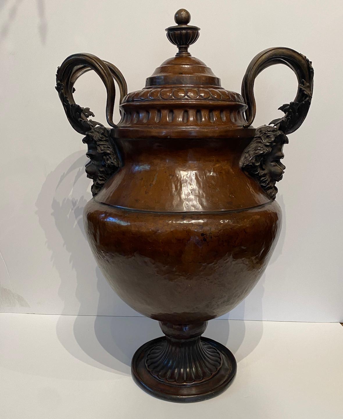 A grand scaled hand pounded copper urn with magnificent cast bronze horned figure mounts.  From Florence, Italy. 