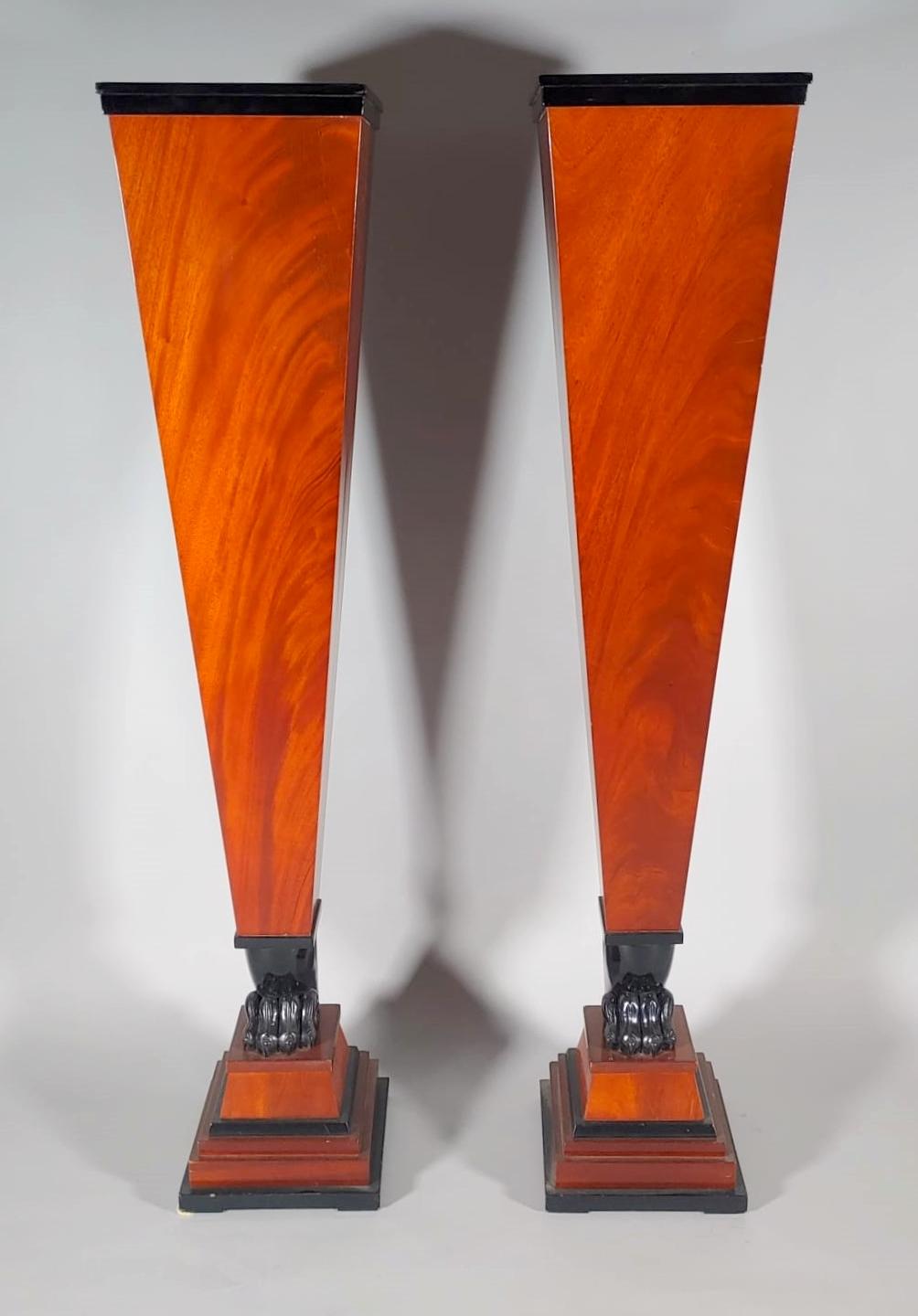 Elegant pair of Austrian columns veneered in blond mahogany and ebonized wood and decorated with lion's paw. Black marble top.
Biedermeier Era  circa 1840.
Origin Austria.
Dimensions: H. Cm.125, W. Cm. 25.5, D. Cm. 25.5.