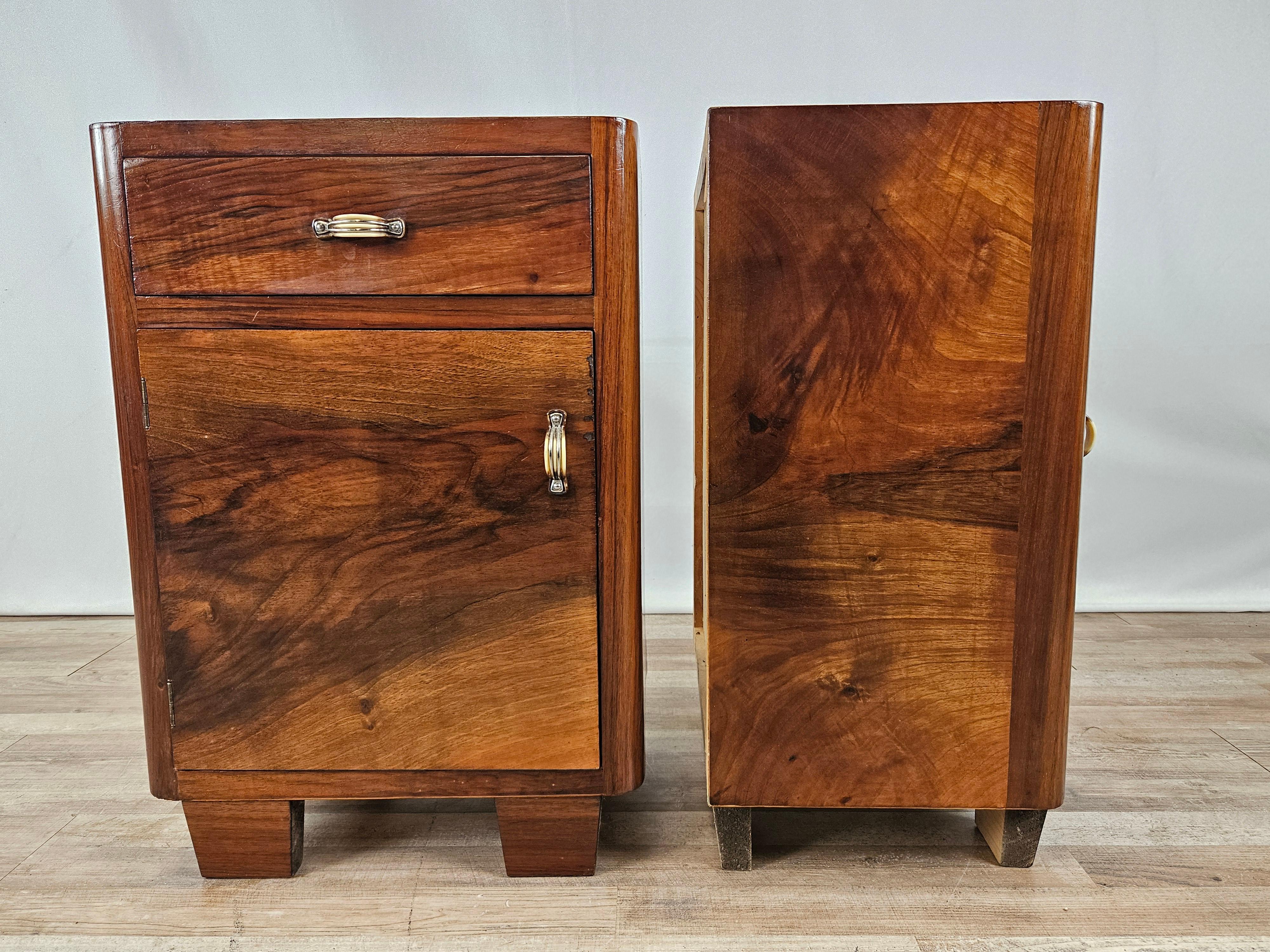Early 1940s room nightstands in Deco style with door and drawer.

Very distinctive and designer handles.

The nightstands have been oil and shellac polished; they show normal marks due to age and use.
One of the handles of a drawer is damaged