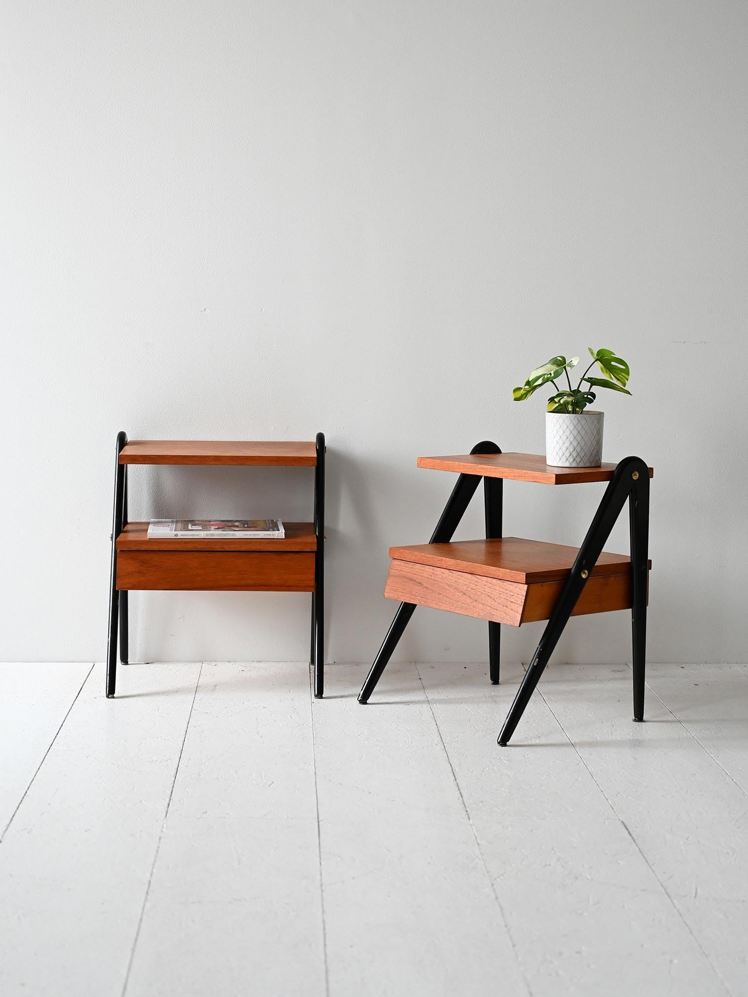 Tables de chevet vintage scandinaves avec un cadre incliné, une finition noire, une étagère ouverte et un tiroir en dessous.

Paire de tables de chevet scandinaves des années 1960 avec un cadre en bois et des détails noirs proéminents. Le profil