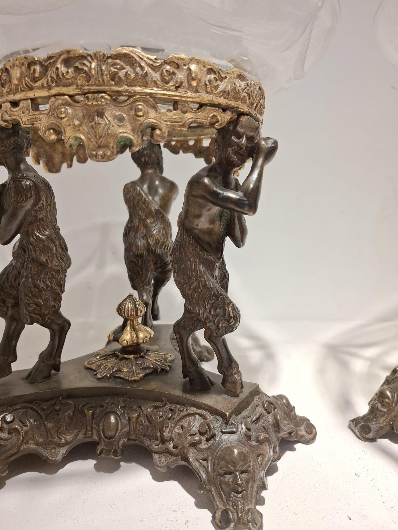 Pair of bronze centerpiece risers with double patina, three fauns support a gilt bronze crown on which rests a beveled crystal plate with festoons and central star, France, first half of the 19th century, height 22 cm, diameter of the plate resting
