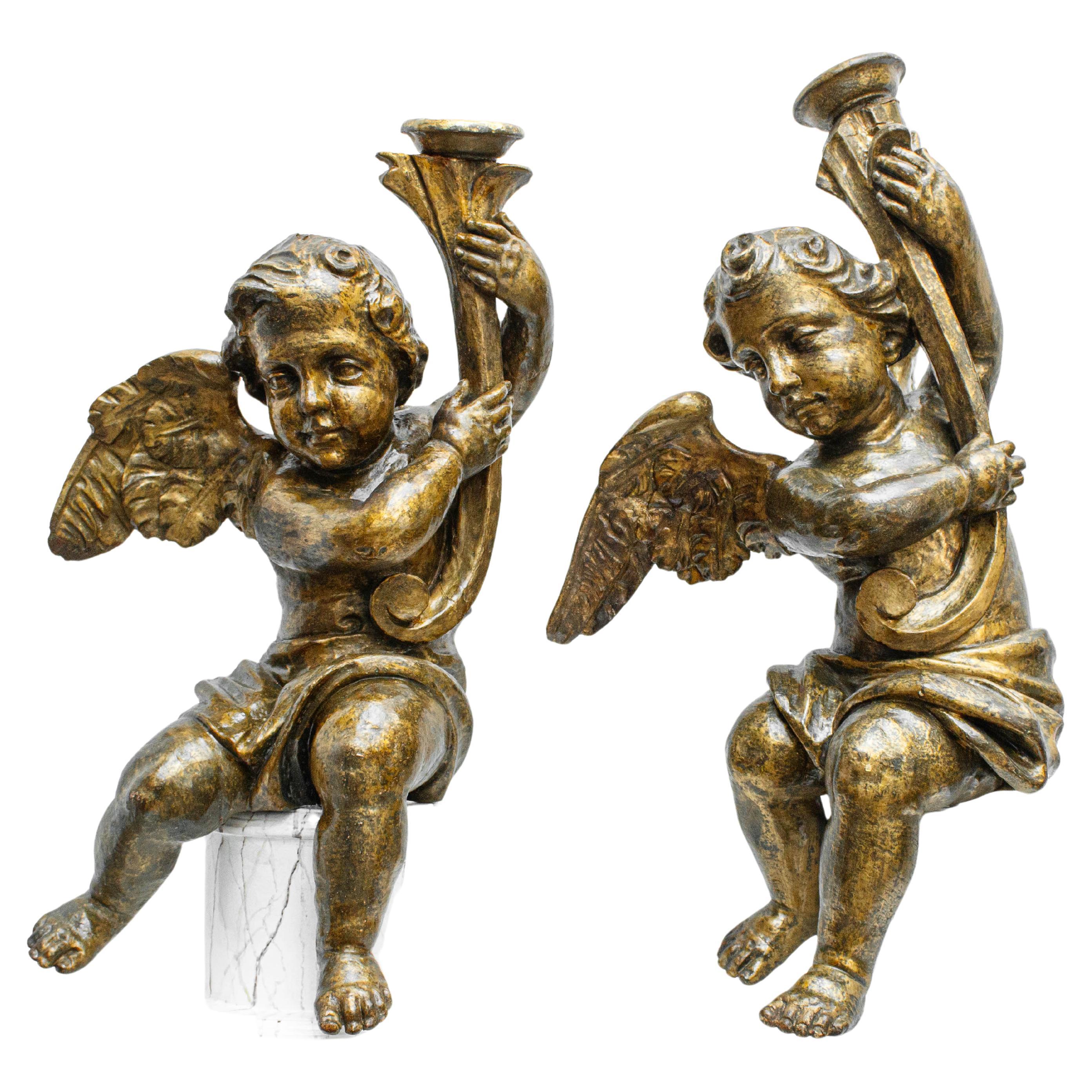 Pair of candle-bearing angels, Carved and gilded wood, 18th century For Sale