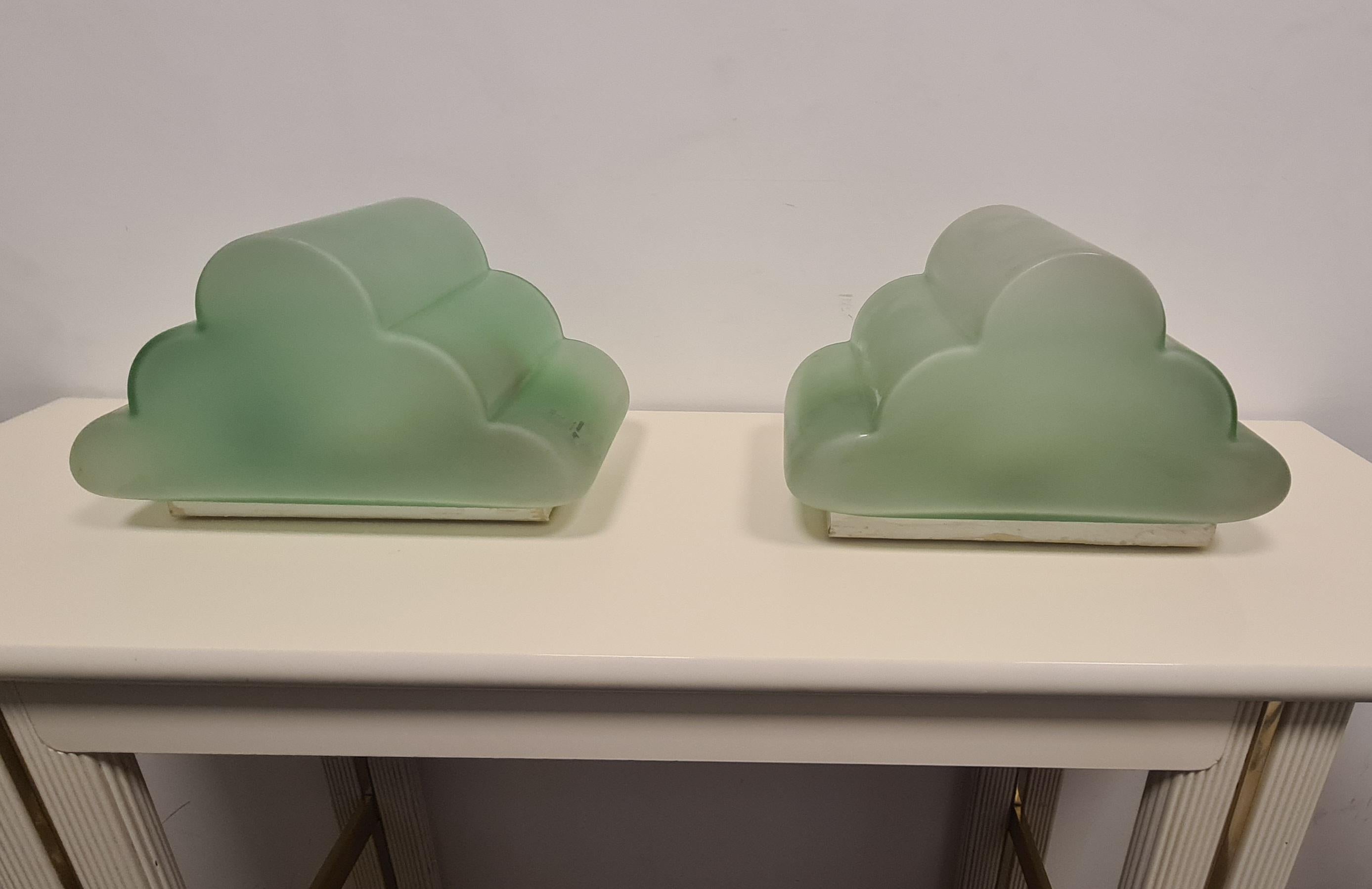 Pair of cute cloud-shaped wall sconces.

The wall sconces have a white metal base, while the hat is made of Tiffany green frosted murano glass.

This pair of fairy-tale wall lamps were made by Murano-based company Murano Due Venezia.

Ideal for