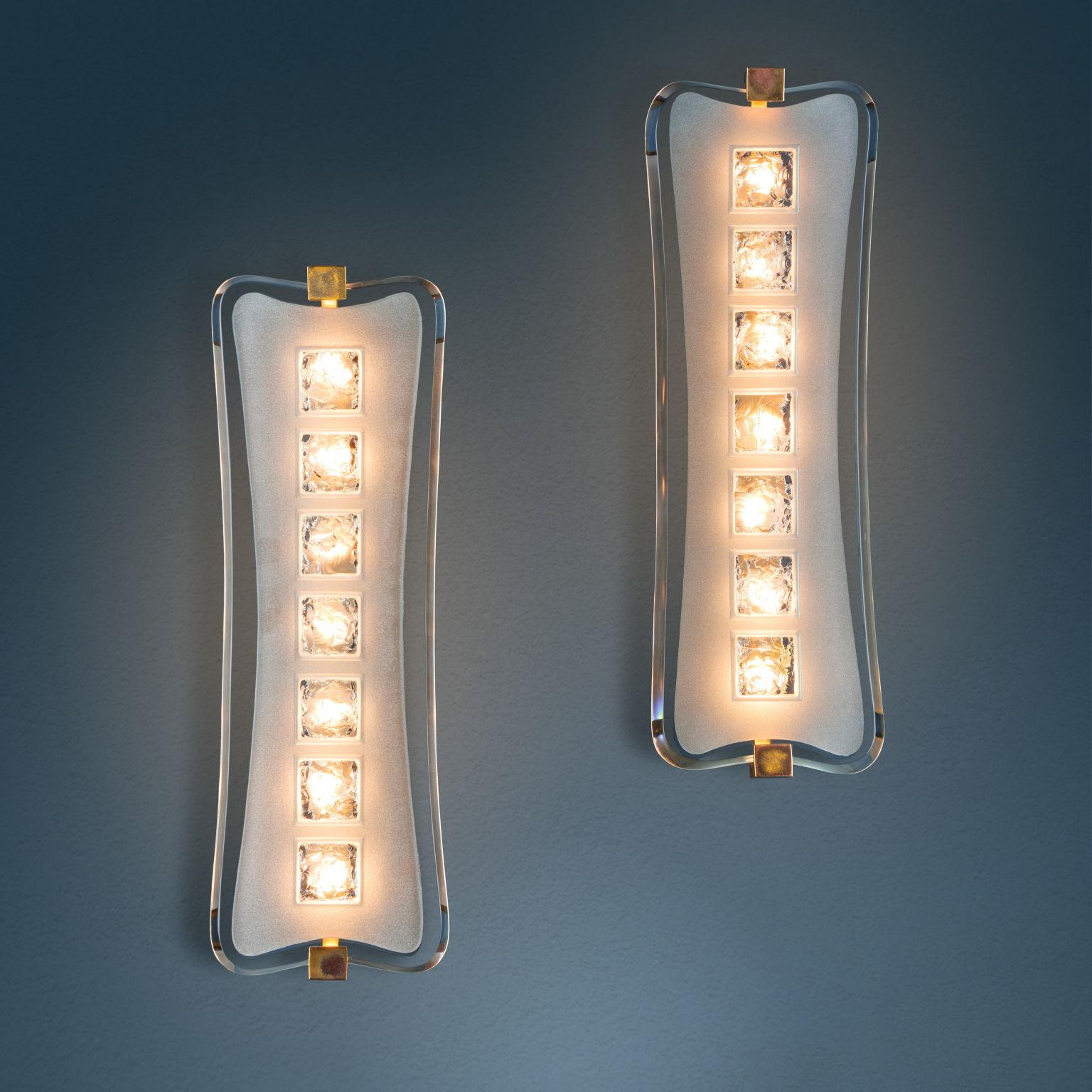Pair of sconces with satin-finished curved crystal screen with chiseled squares, brass frame partly polished nickel-plated. circa 1956. 1950s-60s in very good original condition. 