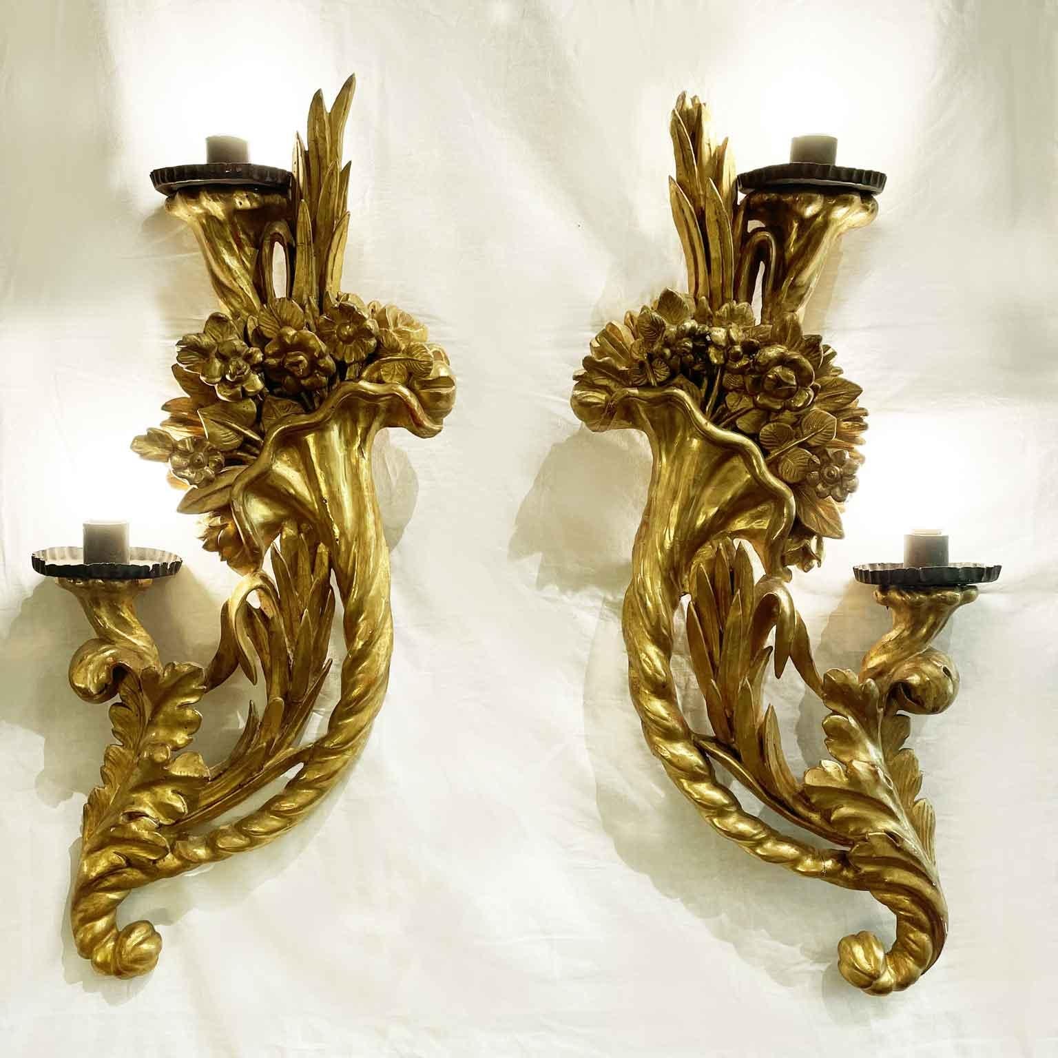 Pair of 18th-century Italian Gilt Wood Carved Appliques with elegant cornucopias and Foliate and Floral Intaglio.  in good condition, are two very rare twisted cornucopias filled with carved flowers and plant and leaf motifs. The two horns of plenty