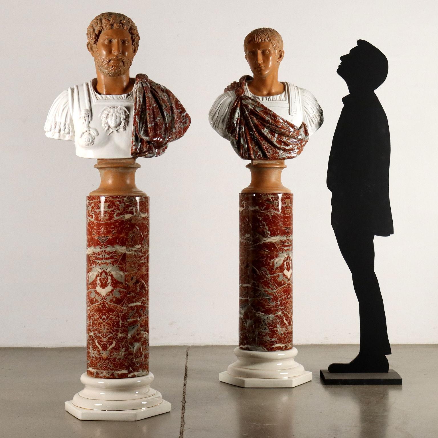Pair of ceramic busts of Roman Emperors resting on ceramic columns, production Tommaso Barbi 1970s. Columns with hexagonal base of white glazed ceramic ornamented with gold piping, shaft imitating a red breccia marble; busts depicting Emperors