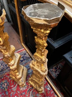 Pair of richly carved candlesticks, gilded with gold leaf, Italy