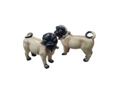 Pair of painted terracotta pugs, Italy, 20th century.