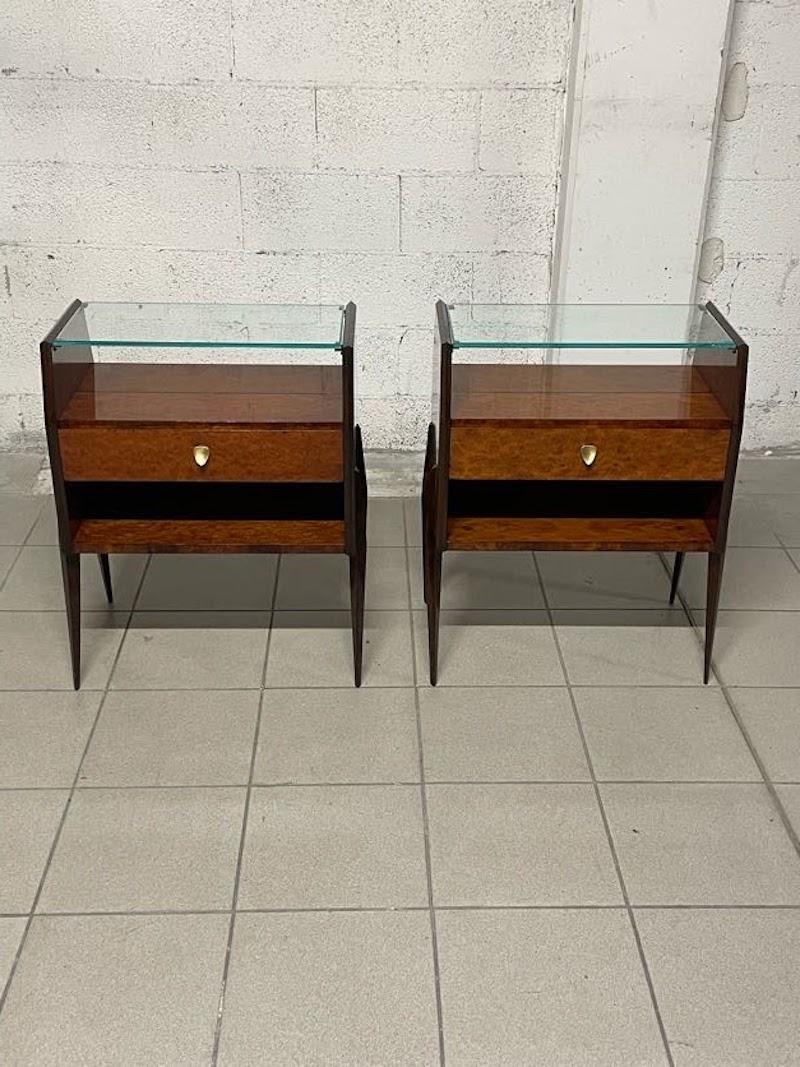 Pair of fully restored 1950s nightstands.

The frame is made of elm burl, glass top shelf and brass handles.

Elegant, small in size, and in excellent condition.