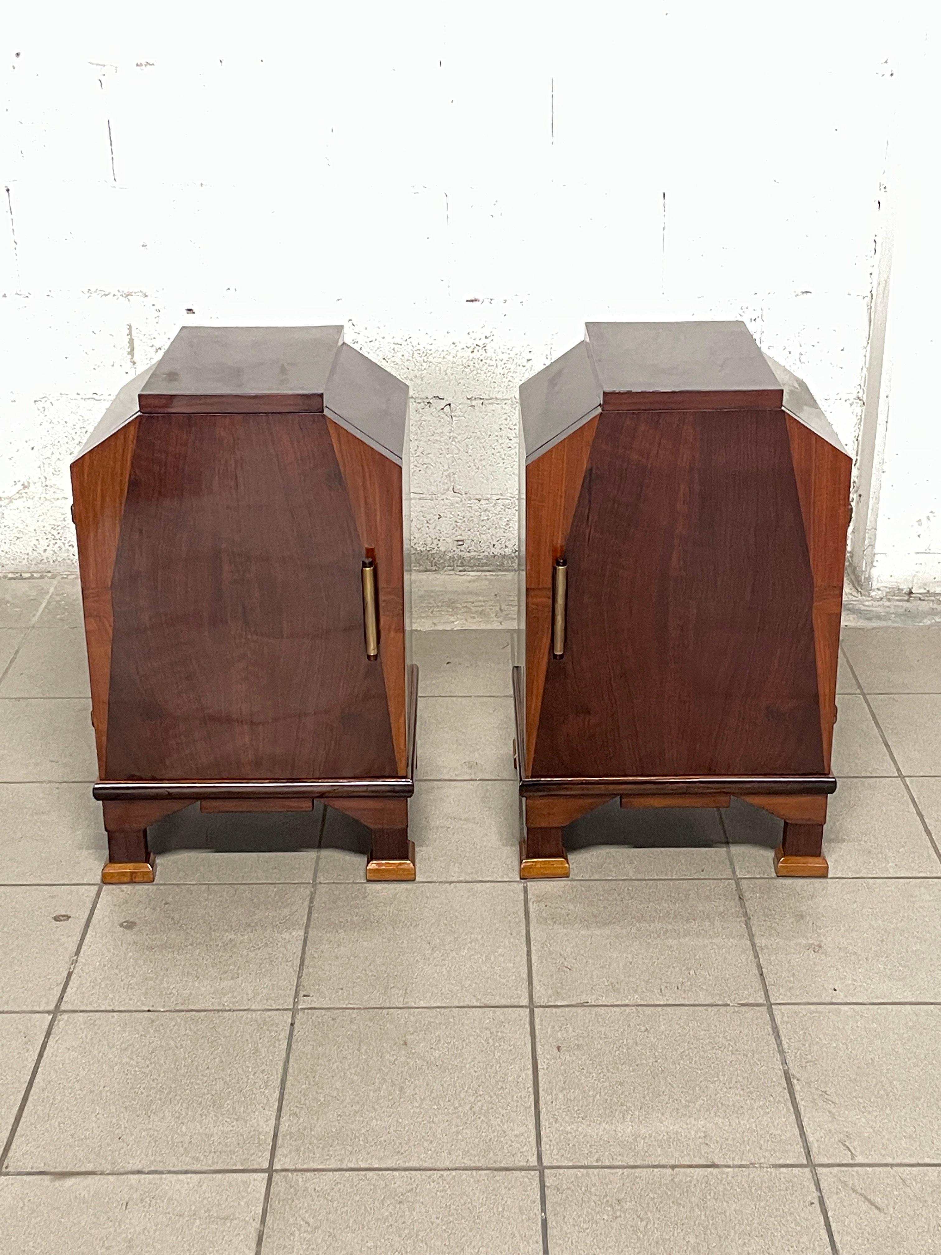 Pair of art deco nightstands dating from the 1930s-40s.

Mahogany wood frame with brass handle.

Perfectly restored and lacquered to impart the luster typical of furniture of that period.

Interior shelves give it an additional finish such as the