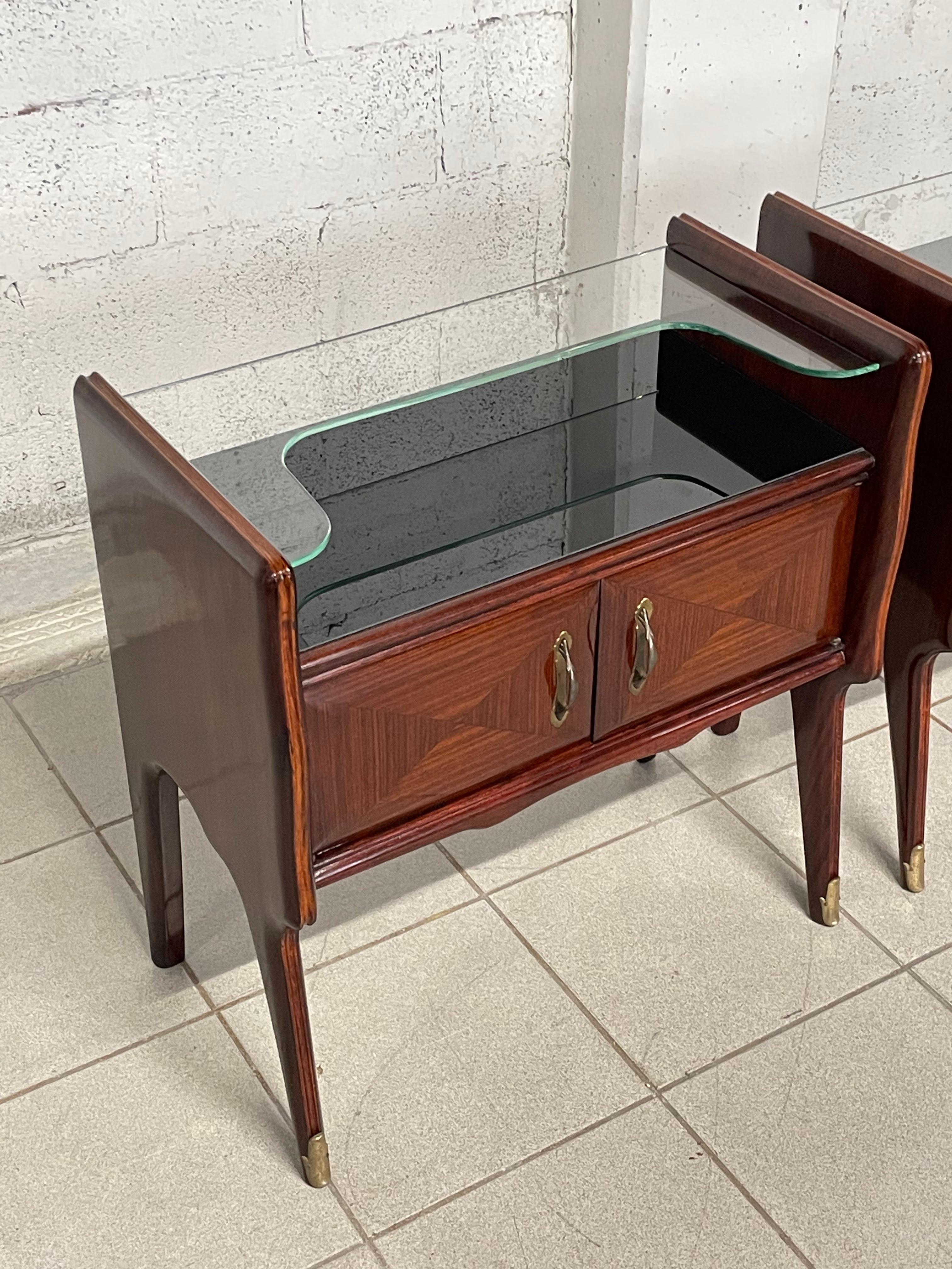 20th Century Pair of mahogany and glass bedside tables from the 1950s