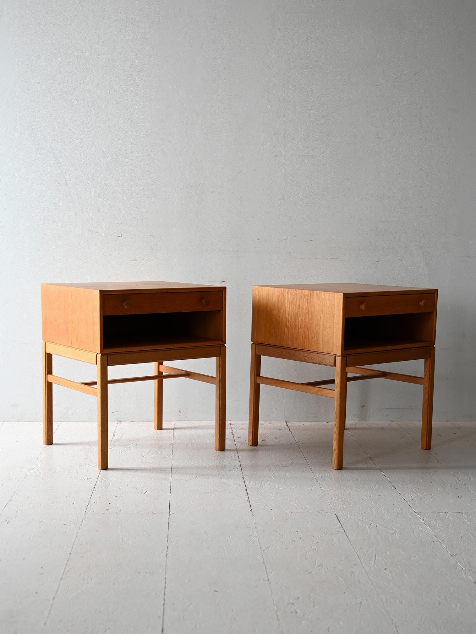 Pair of vintage oak bedside tables, Tingströms manufacture, Casino model. Clean design with drawer, round handles and storage shelf.

Pair of Scandinavian oak bedside tables, model 