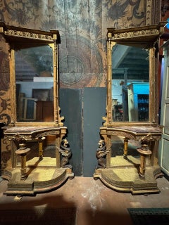 Pair of gilded side tables with a mirror and a marble tabletop