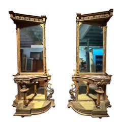 Pair of gilded side tables with a mirror and a marble tabletop