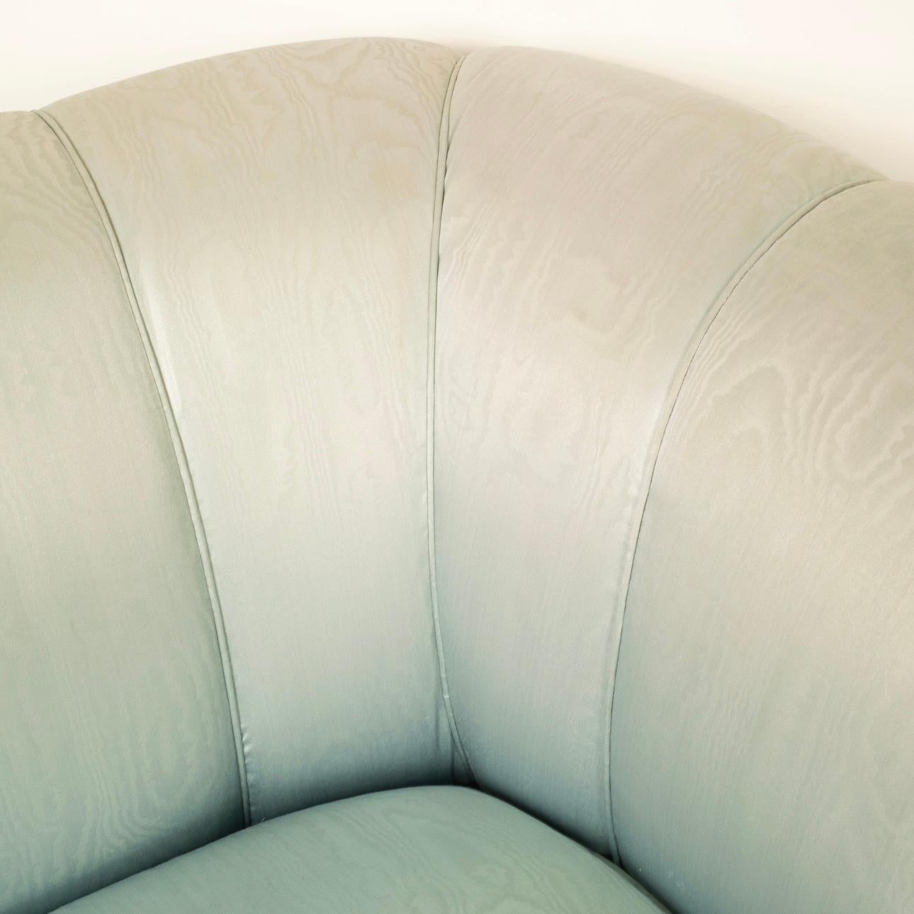 Discover the unique beauty of a pair of vintage sofas designed by architect Fabrizio Smania for Smania Studio Interni in the early 1980s. These sofas are distinguished by their extraordinary iridescent blue moiré silk upholstery, which is still in
