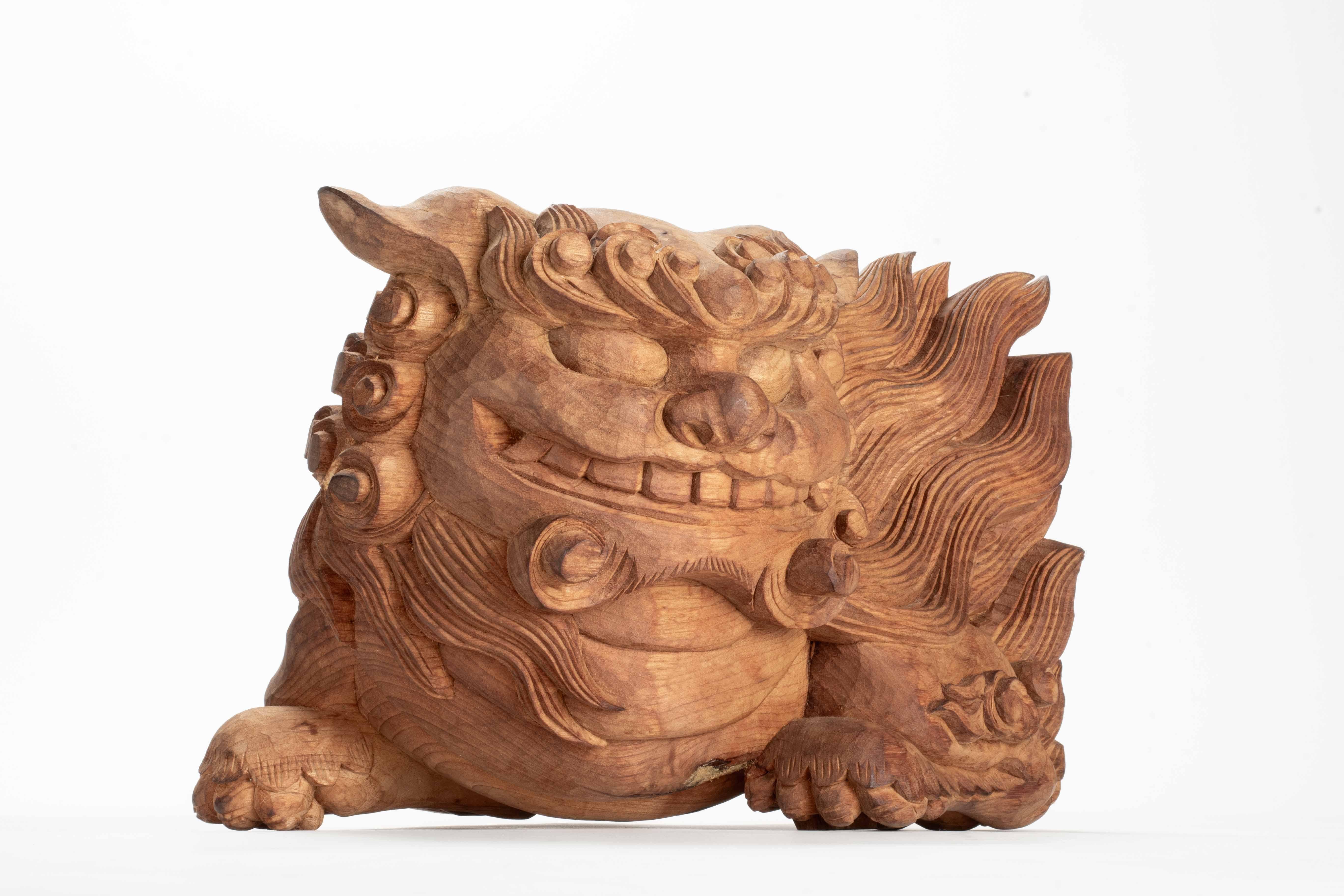 Pair of kibana, carved wooden ornaments used in Japanese Buddhist temples, carved in the shape of mythical lion-like creatures called shishi. 

Period: Meiji late 19th cent.  
Dimensions: 21 x 32 x 20 cm.
Conservation status: Excellent condition.