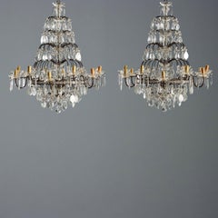 Pair of Twelve-Light Chandeliers in burnished metal Italy Early 20th Century.
