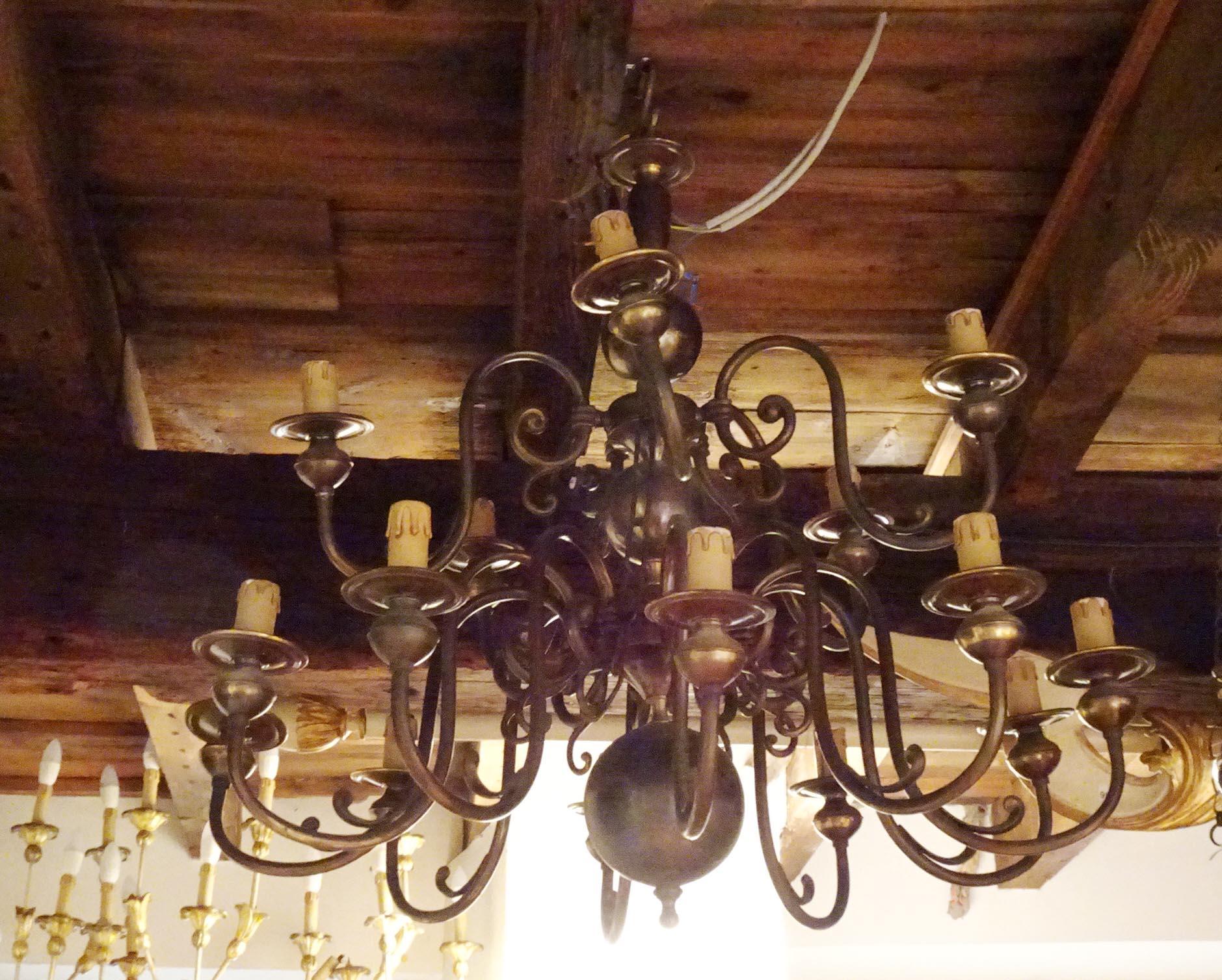 The two dark patinated bronze chandeliers are 17th-century Dutch-style copies made in the second half of the 19th century. 
The tendency to create works inspired by this period can undoubtedly be traced to its historical relevance: the Dutch Golden