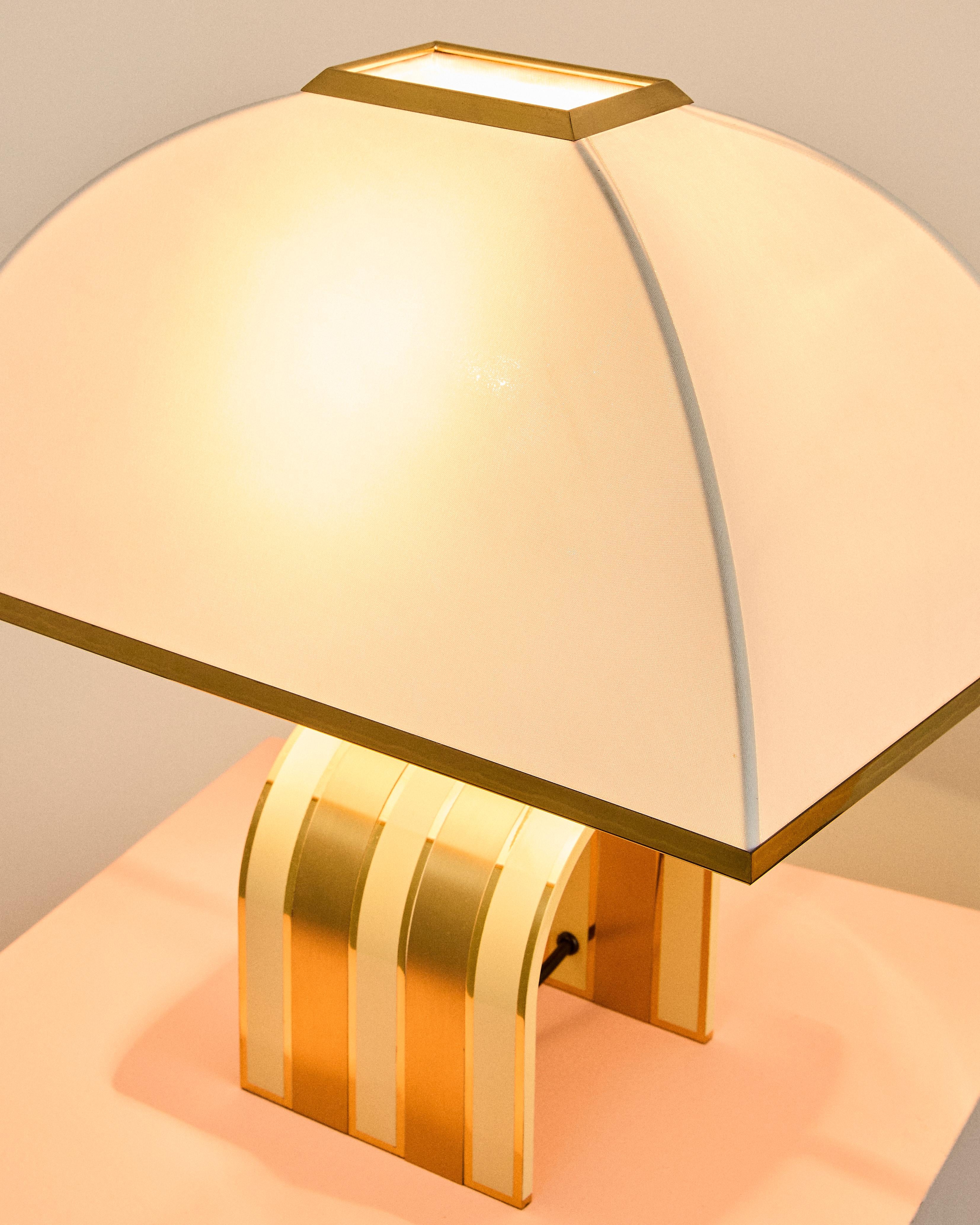 Pair of brass and lacquered brass lamps attributed to Romeo Rega and produced by Fratelli Martini in the 1970s. The lampshades are the originals; they are two stock items.