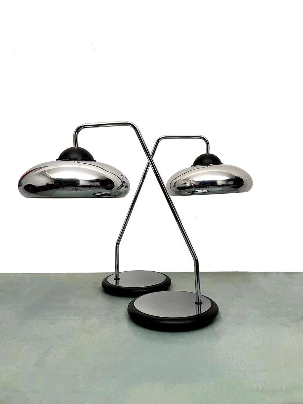 Rare pair of table lamps mod. 2101 Ministeriale produced by Stilnovo. Swiveling lampshade made of pressed sheet metal, chromed bent tubular stem and cast iron base covered with black lacquered sheet metal casing with chromed plate. Documentation
