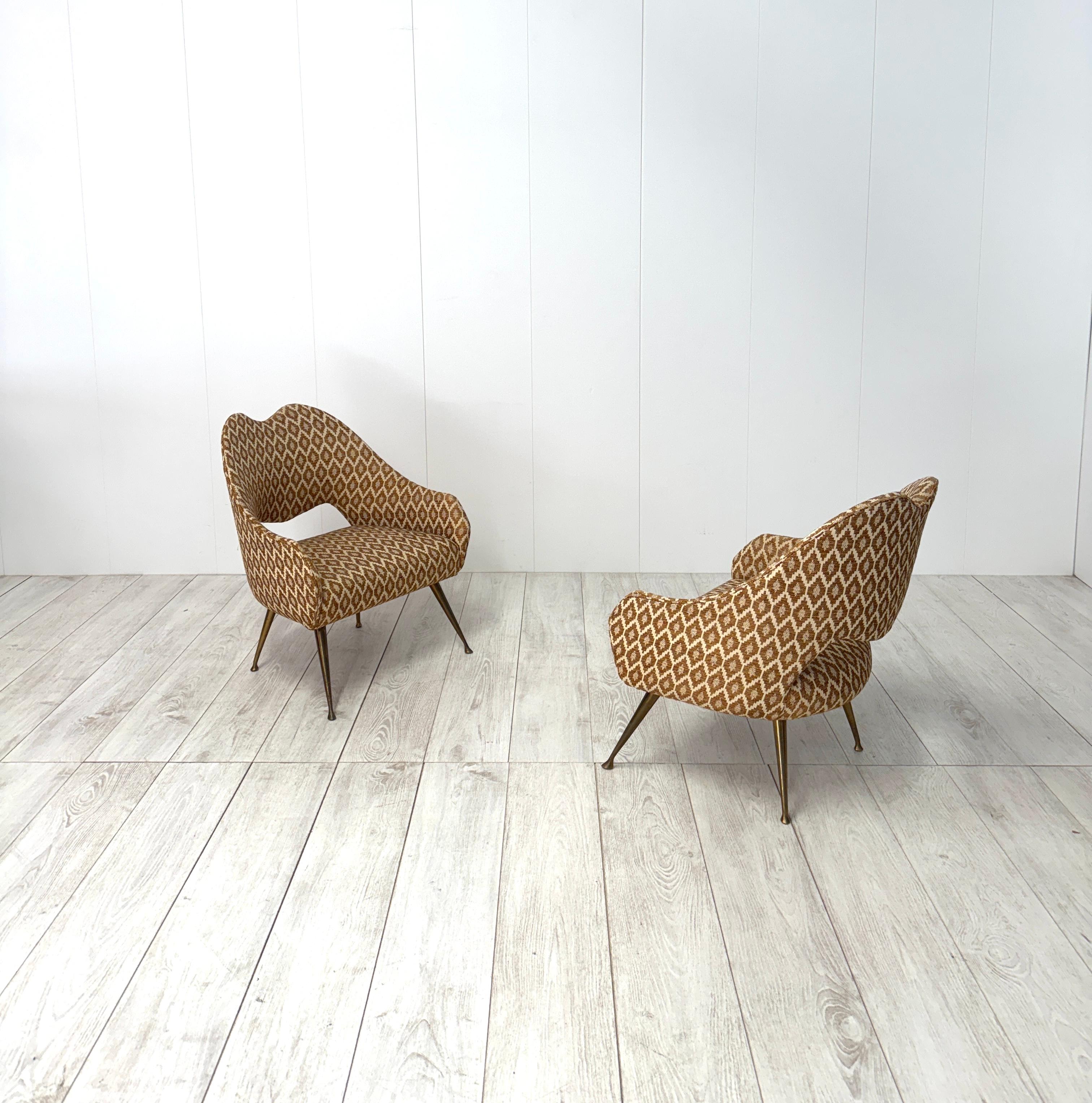 Peculiar small armchairs with wooden frame covered with fabric, brass legs.
Original vintage fabric
