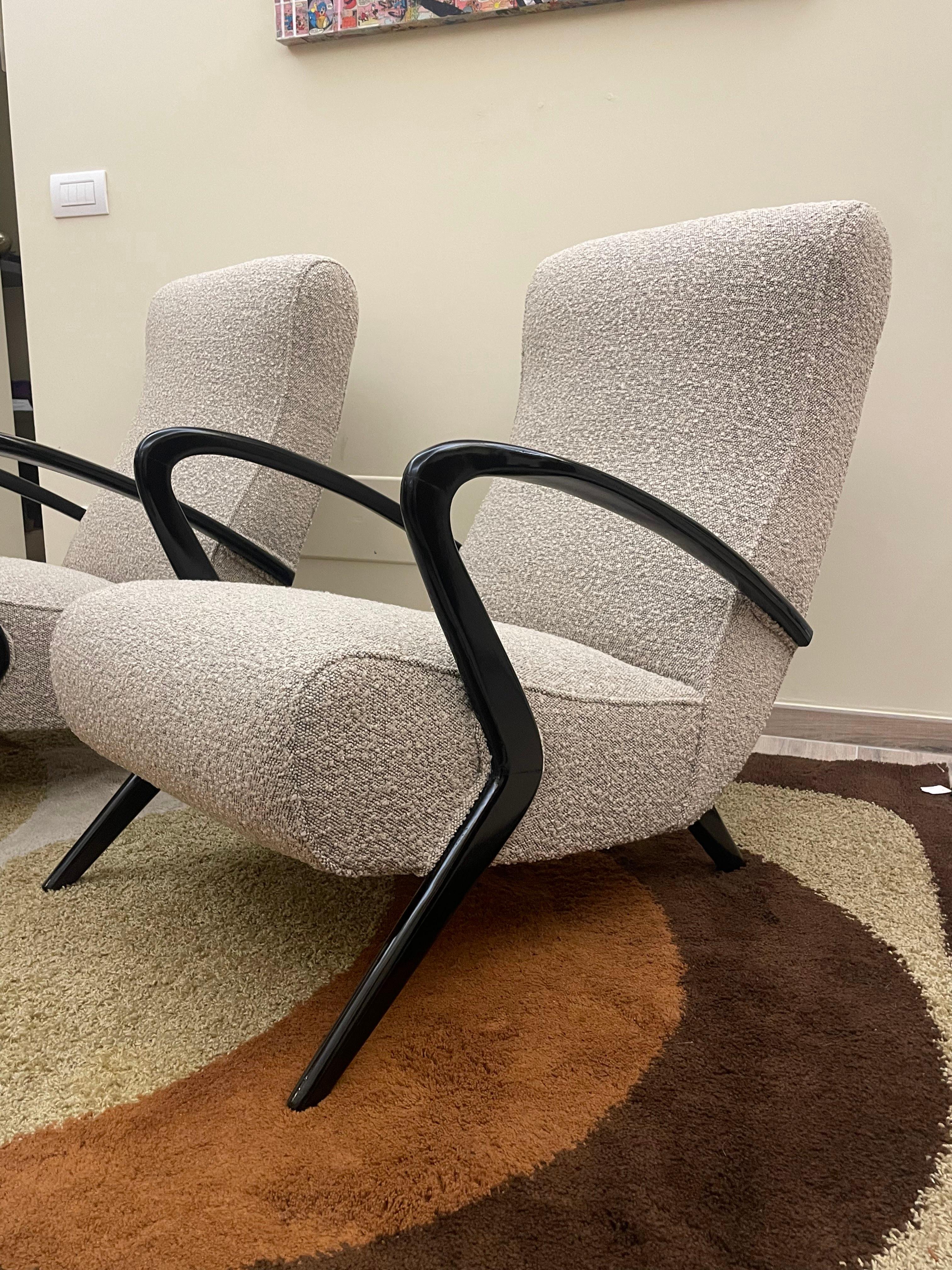 Pair of 1950s armchairs of Italian manufacture.
Armrest frame in stained wood and upholstery in bouclé fabric.
The set has been completely restored for both the wooden parts and the upholstery and covering.
Besides being very comfortable, they lend