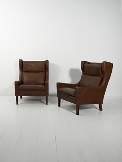 Pair of Danish dark brown leather armchairs