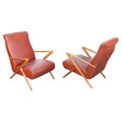 Coppia di poltrone di design italiano degli anni 50, in legno e pelle